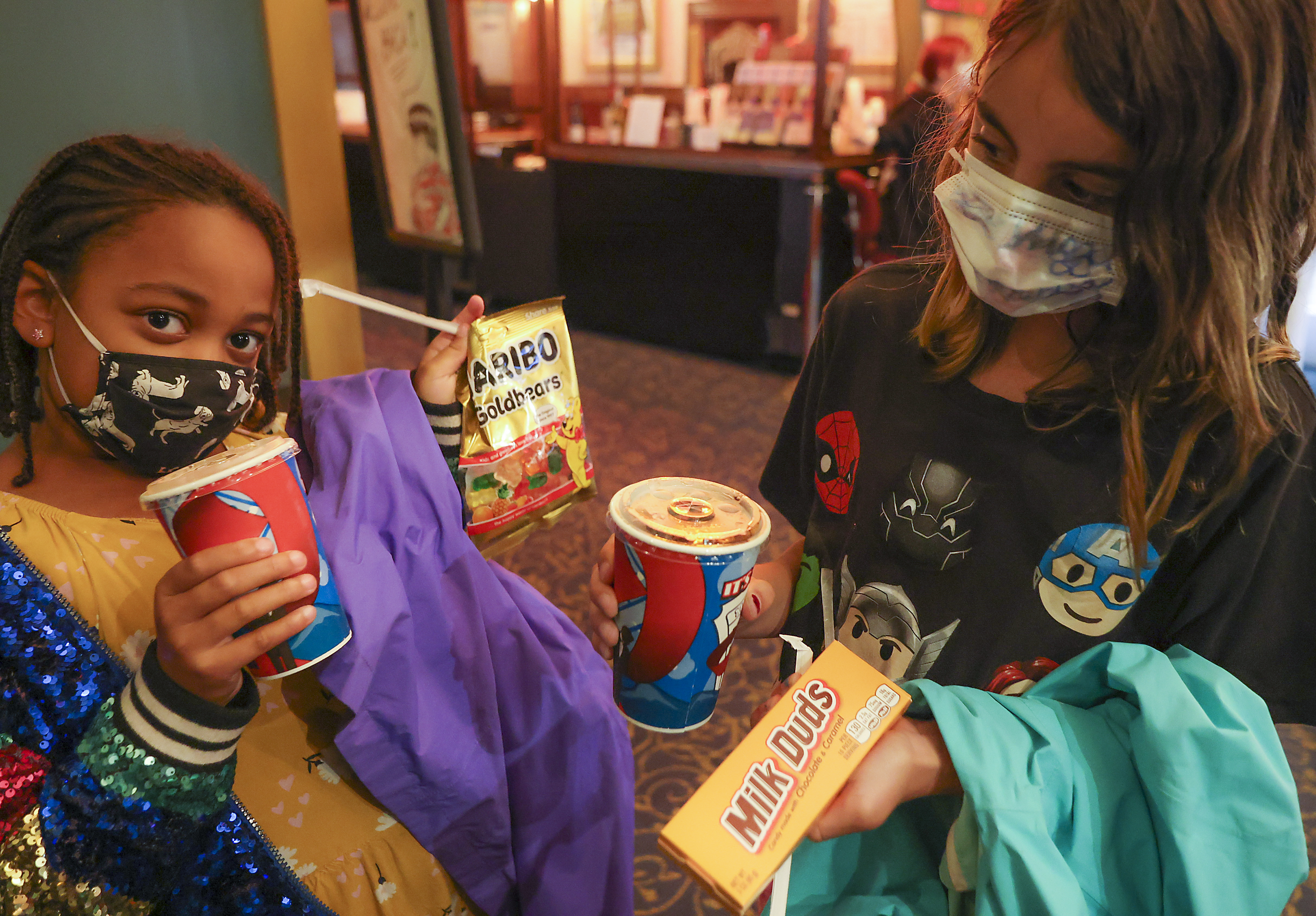 Rachael Lemoine, 8, of Los Angeles, with her cousin Daphne Marquis, 8, of Brookline, held up their movie candy.