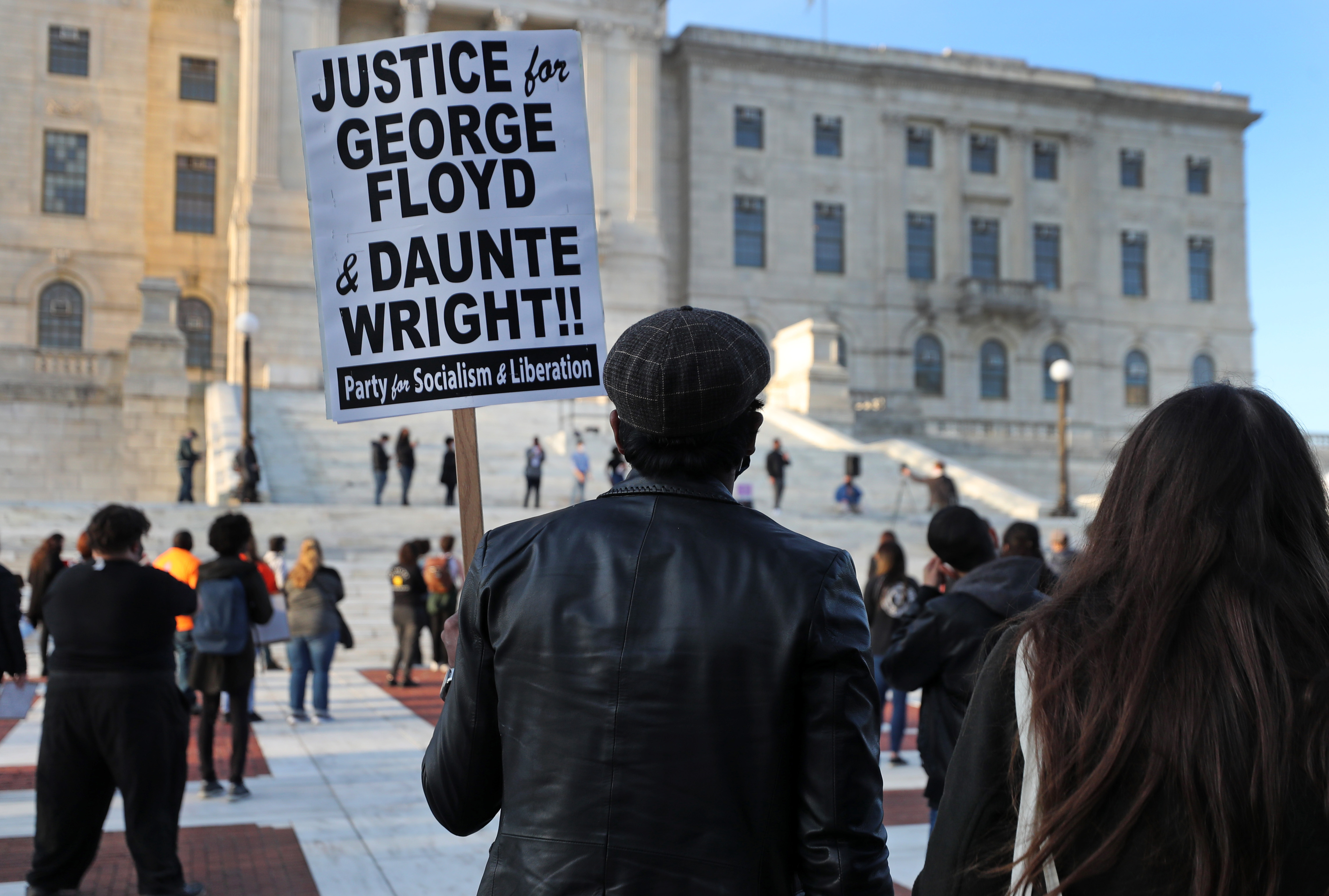 A demonstrator holds a sign during a peaceful protest on the Rhode Island State House steps, organized by Black Lives Matter RI PAC and other groups.