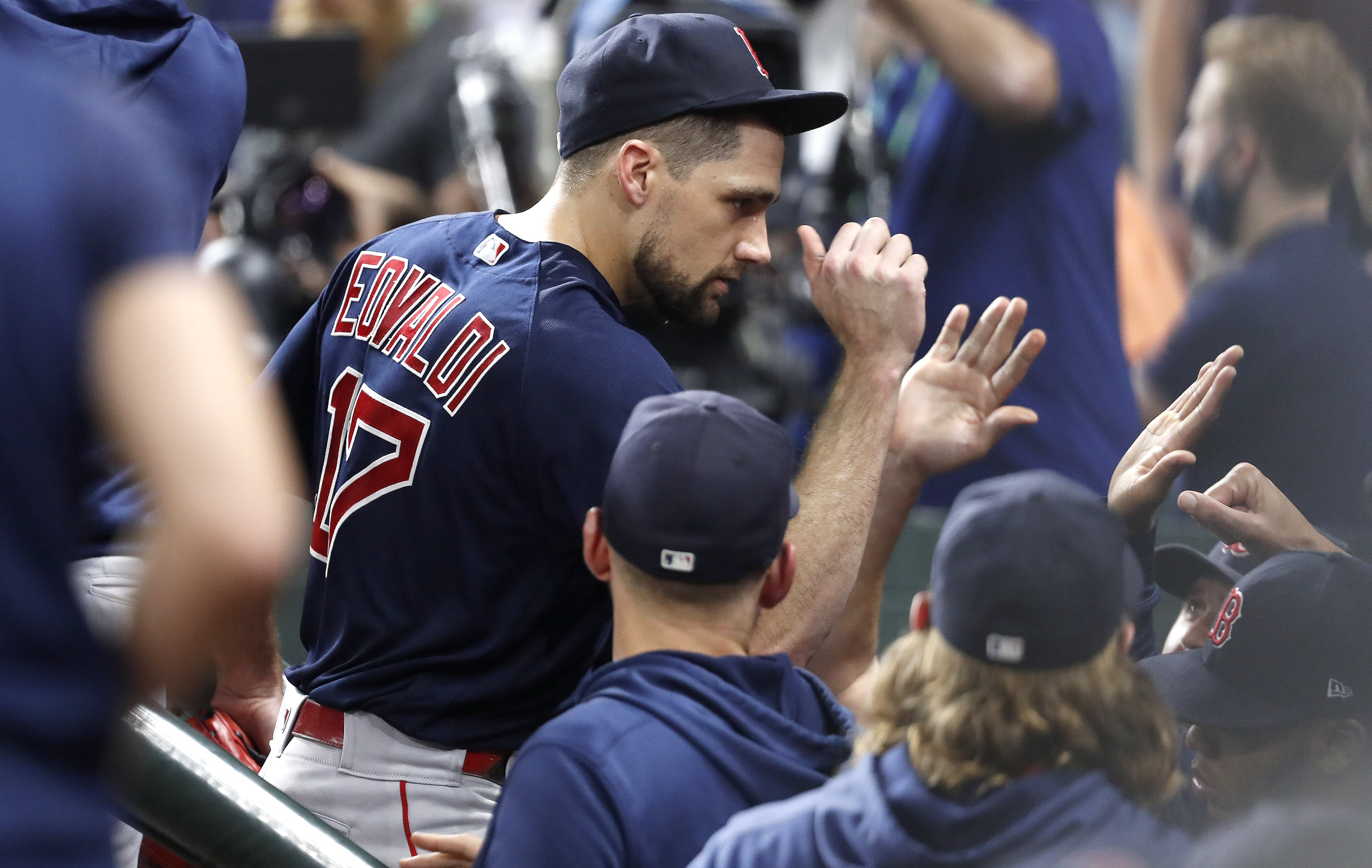 Nate Eovaldi gets high fives from teammates after being pulled in the fifth inning.