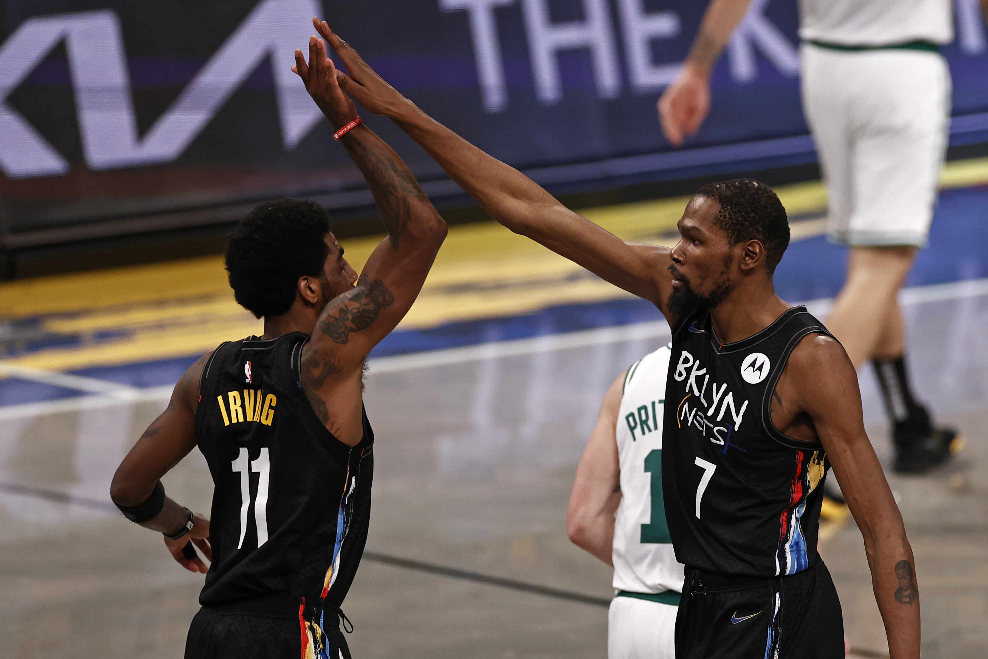 Kevin Durant and Kyrie Irving celebrate as Game 5 ended Tuesday night in Brooklyn.