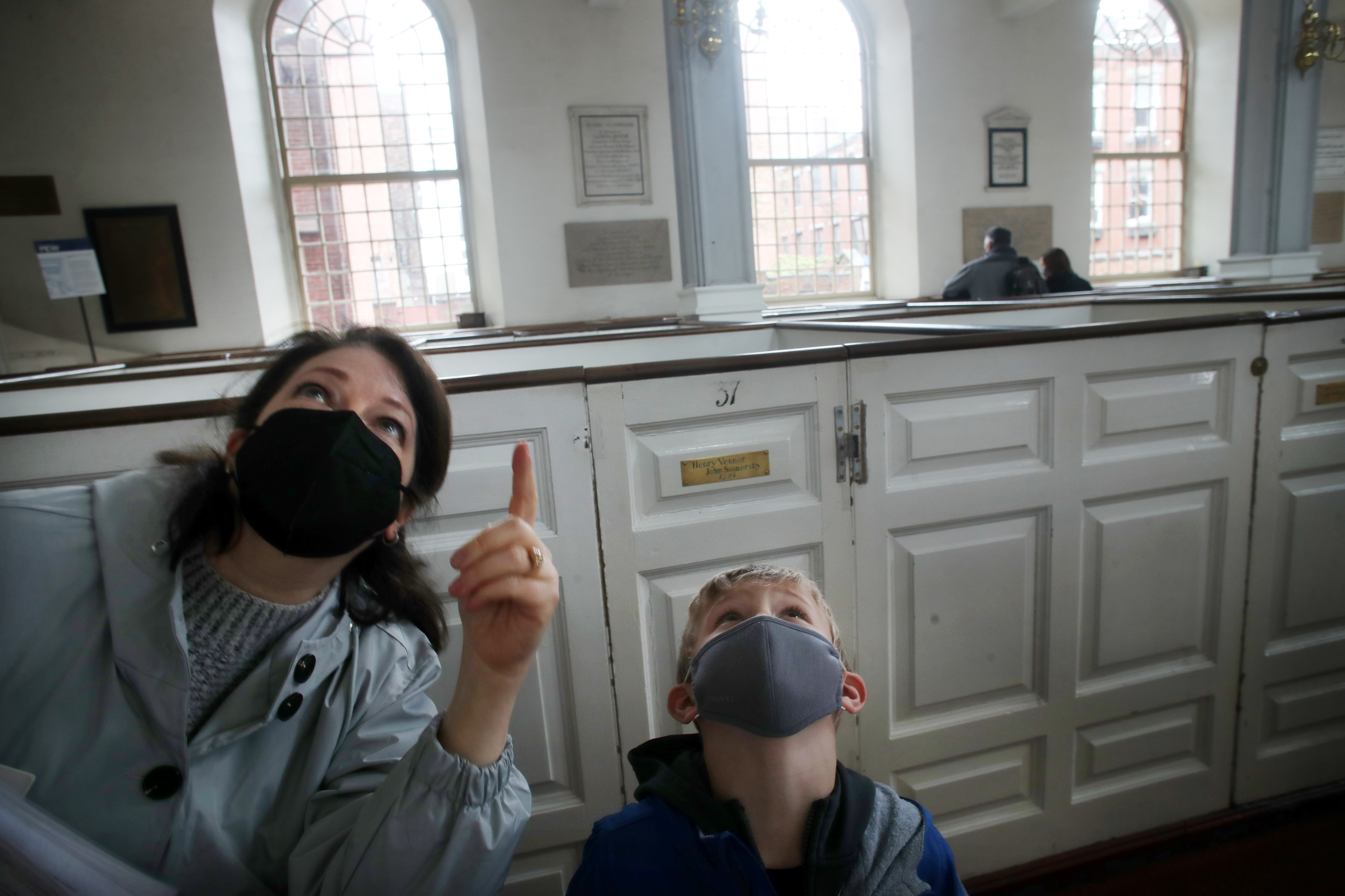 Director of Education Catherine Matthews pointed out a cherub to Teddy DeWitt at the Old North Church in the North End neighborhood of Boston, on April 17, 2021. The Old North Church & Historic Site kicked off Patriots Day Weekend by re-opening its doors to visitors after a 13-month closure in response to the COVID-19 crisis. The city's oldest surviving church is one of the first institutions to re-open along the Freedom Trail.