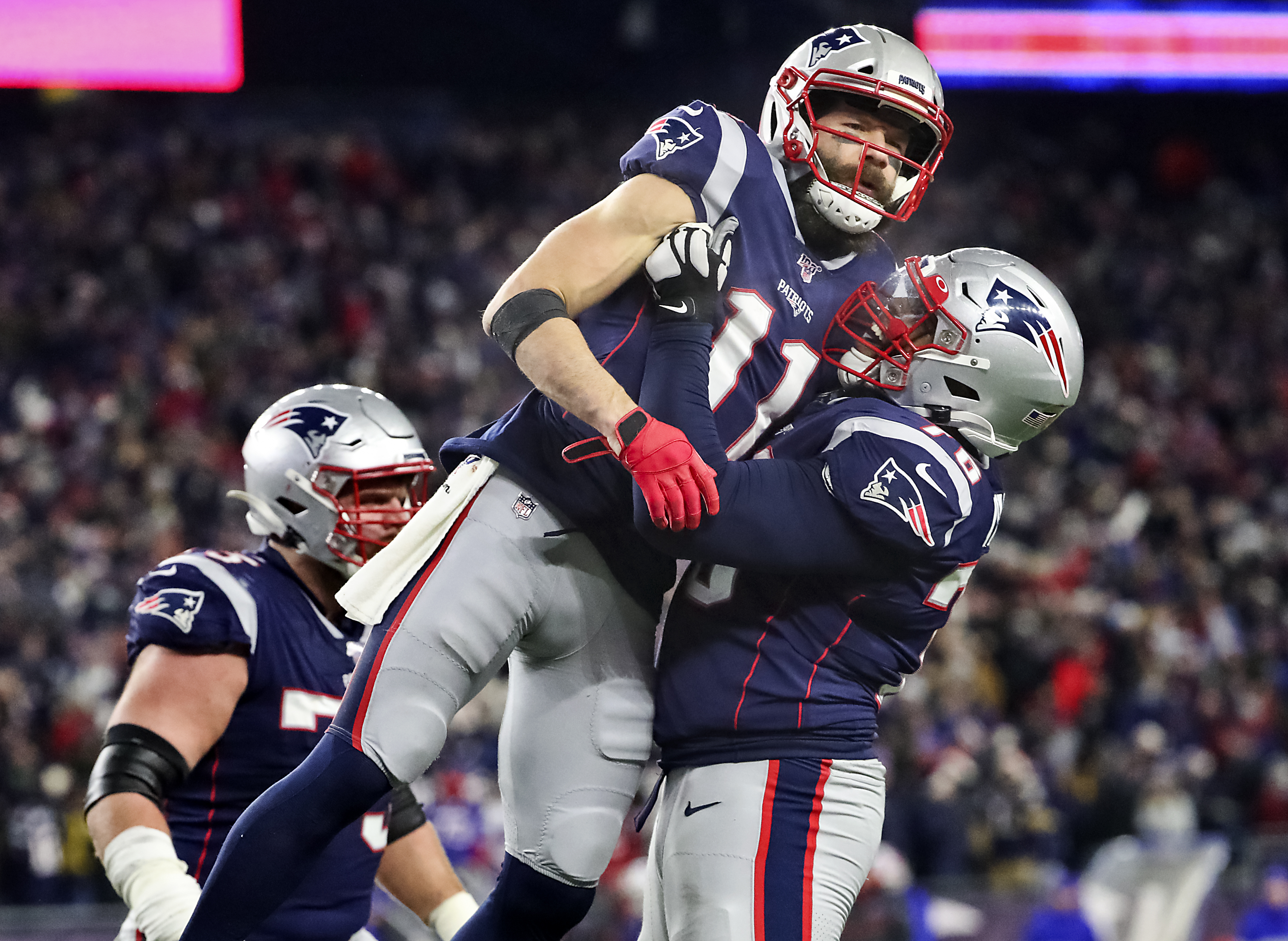 Patriots lineman Isaiah Wynn lifted up receiver Julian Edelman after a successful two-point conversion in New England’s 24-17 win over the Buffalo Bills at Gillette Stadium on Dec. 21.