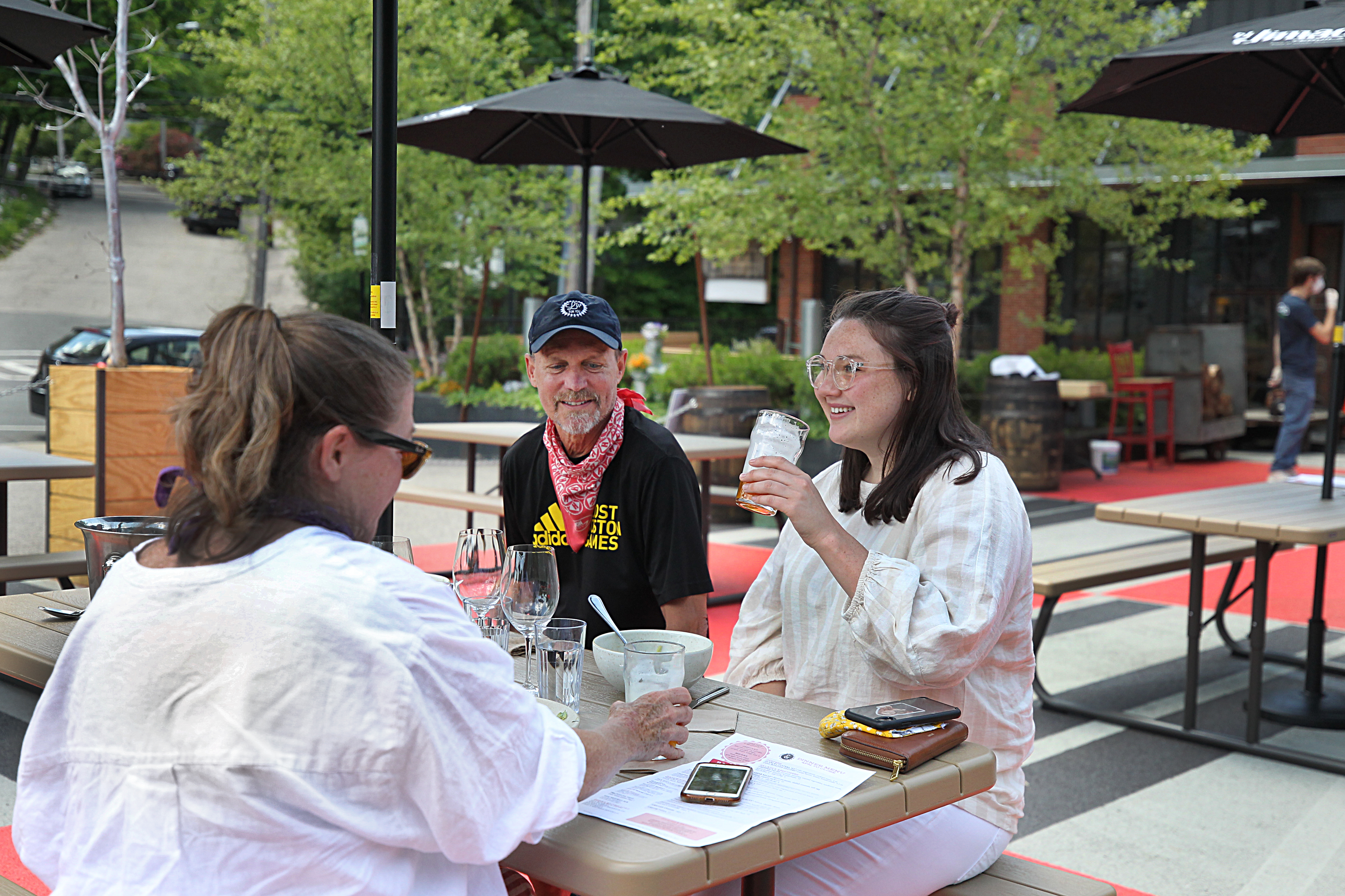 Steel & Rye's first outdoor dining customers, Laura Ryder, her husband Jefferson, and daughter Acadia, enjoy a meal. On Monday, restaurants reopened for outdoor dining as part of the state's Phase 2 reopening plan.