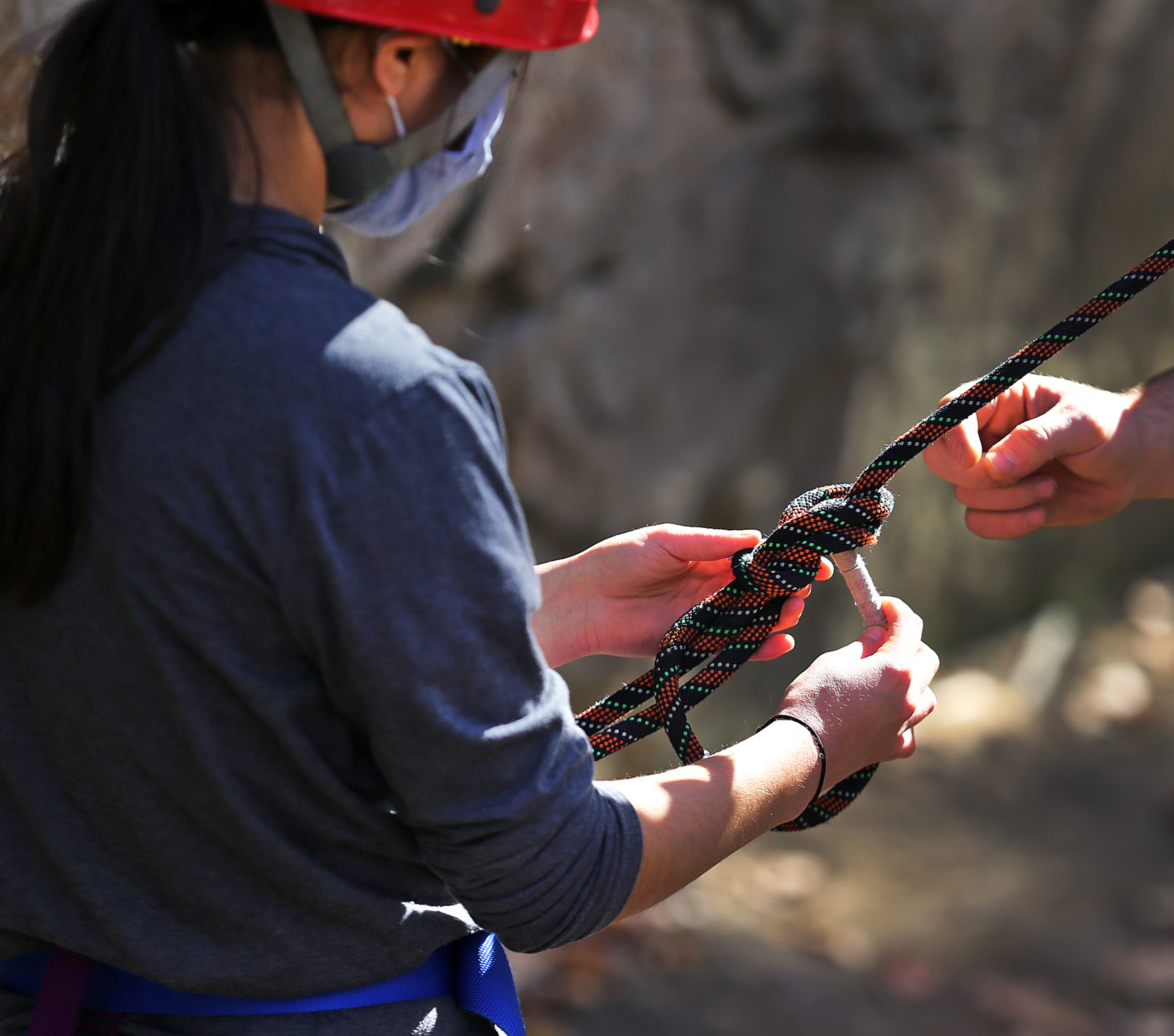 Dan Lewis (not pictured) said his experience at Dartmouth's Outing Club helped him learn skills he's tried to pass on to students such as Lincoln-Sudbury's Katie Johnson (pictured), who prepared her equipment and rope lines before a climb. "There’s been a cultural shift away from that type of education, and classrooms without walls. I’d like to see it come back a bit," Lewis said.