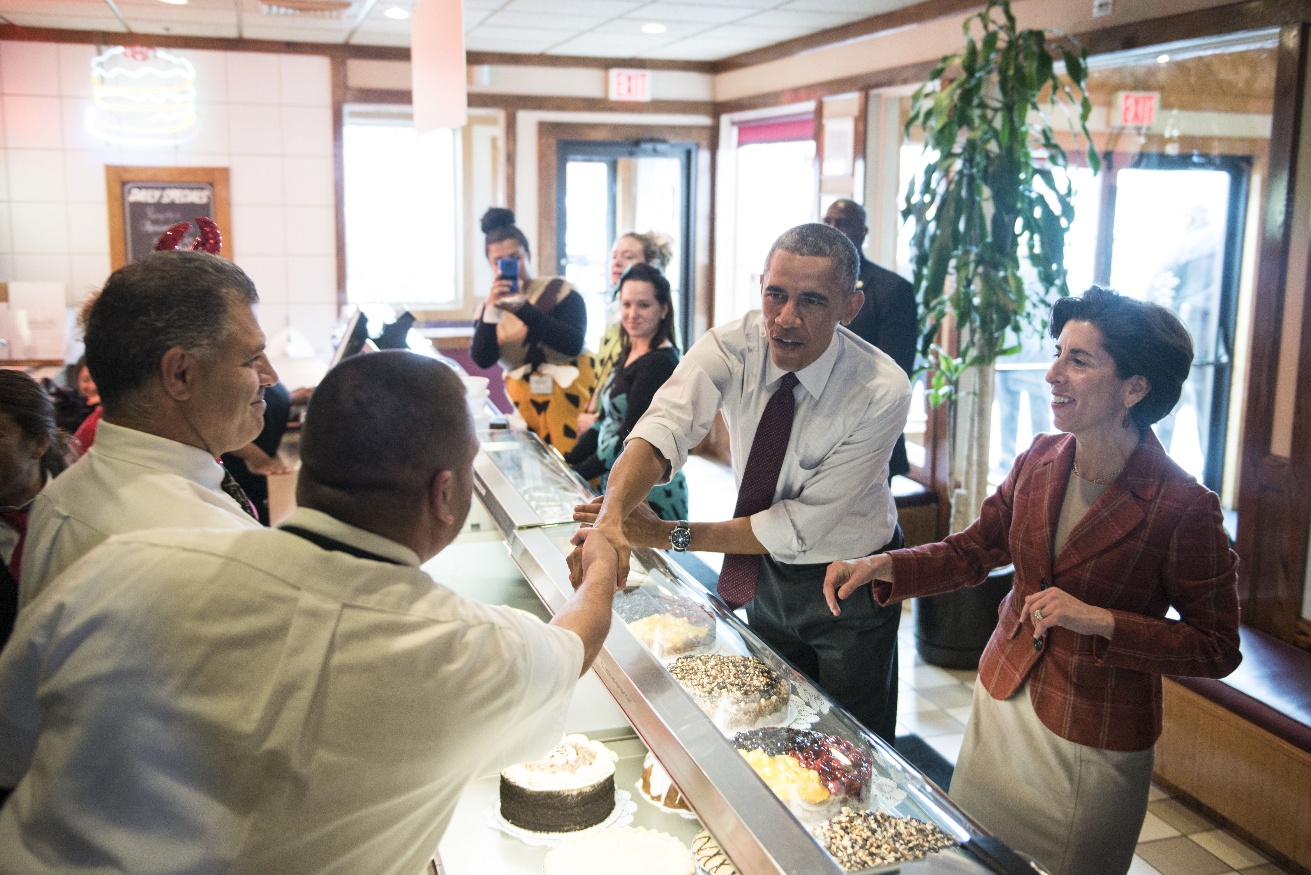 President Obama greeted workers while ordering food with Gina Raimondo at Gregg's Restaurant in 2014.