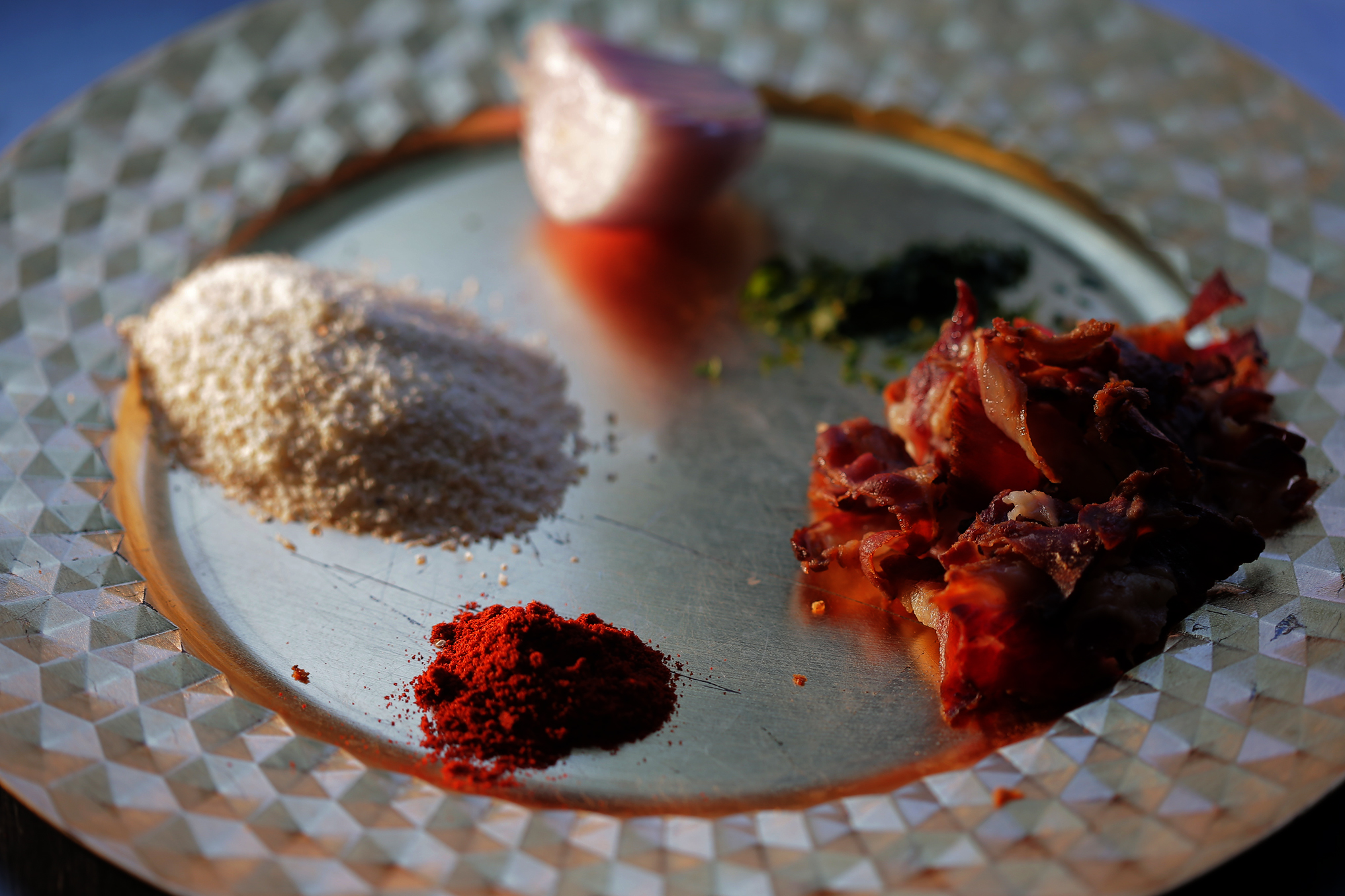 Ingredients for Marcelino’s grits and gravy include grits, shallot, parsley, beef bacon, and paprika.
