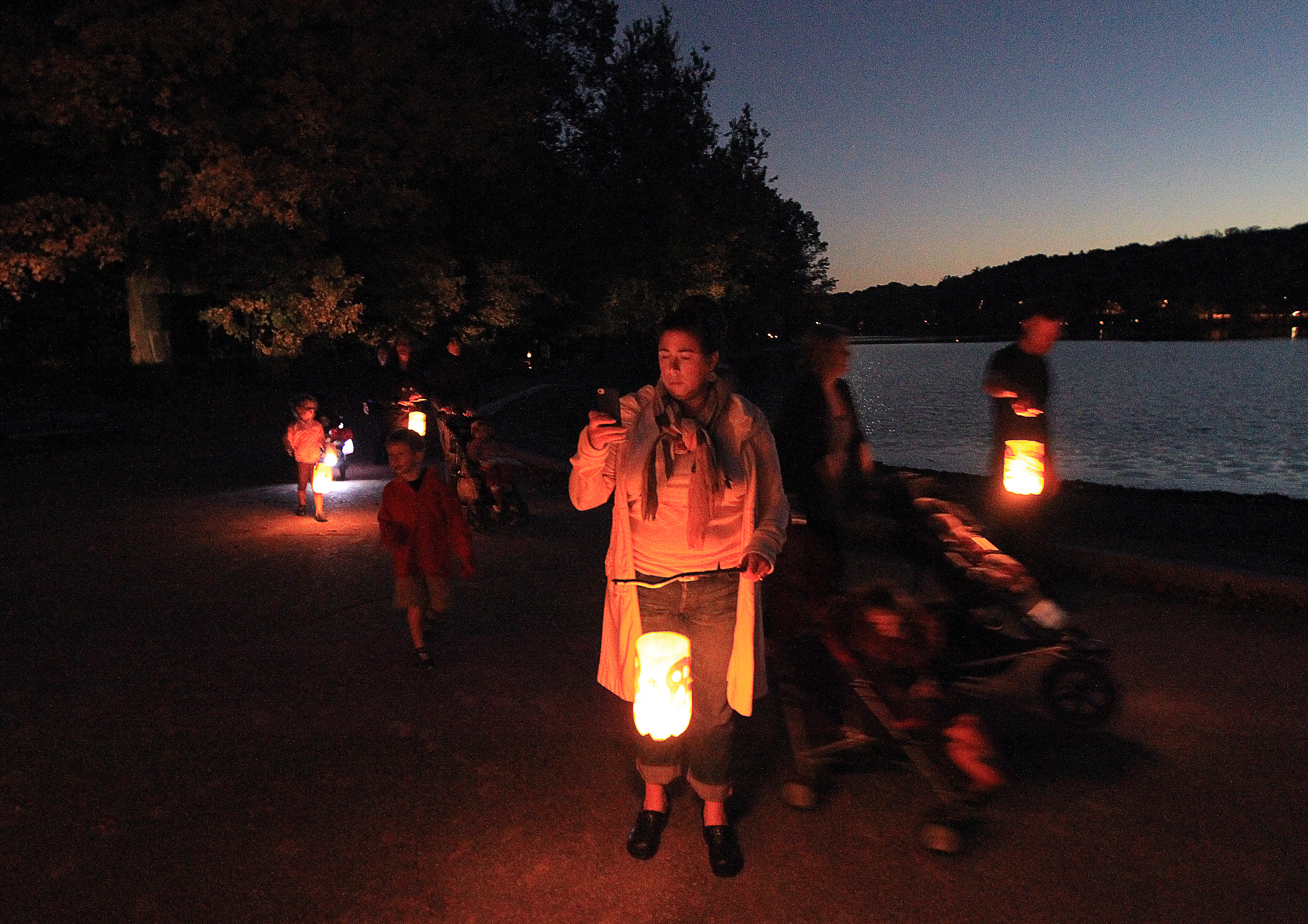 As the sun set on Oct. 20, 2012, visitors to the Jamaica Pond Lantern Parade began to walk around the water.