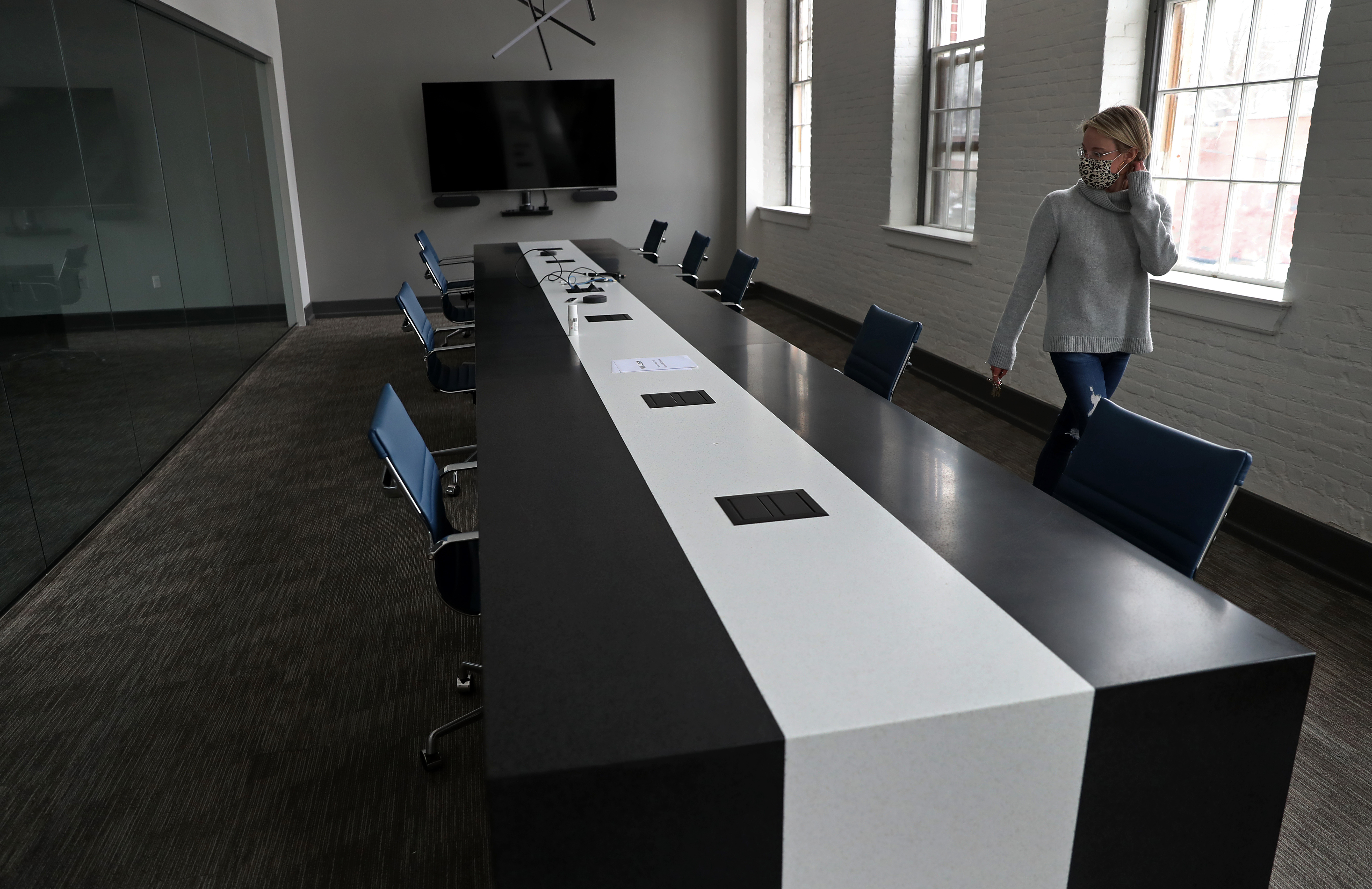Sondrup checked to confirm that the chairs in a conference room were adequately socially distanced ahead of a future meeting with some employees.