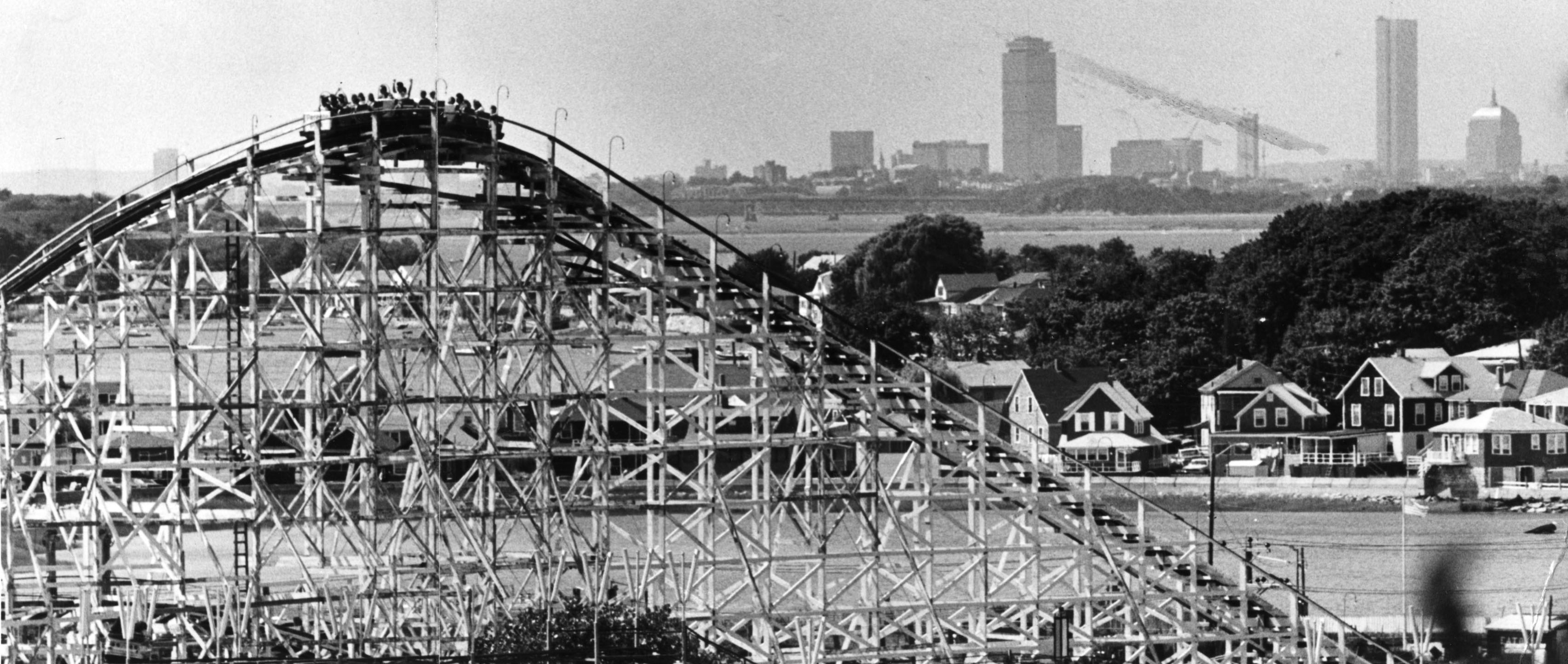 Paragon Park's roller coaster with the Boston skyline in the distance.