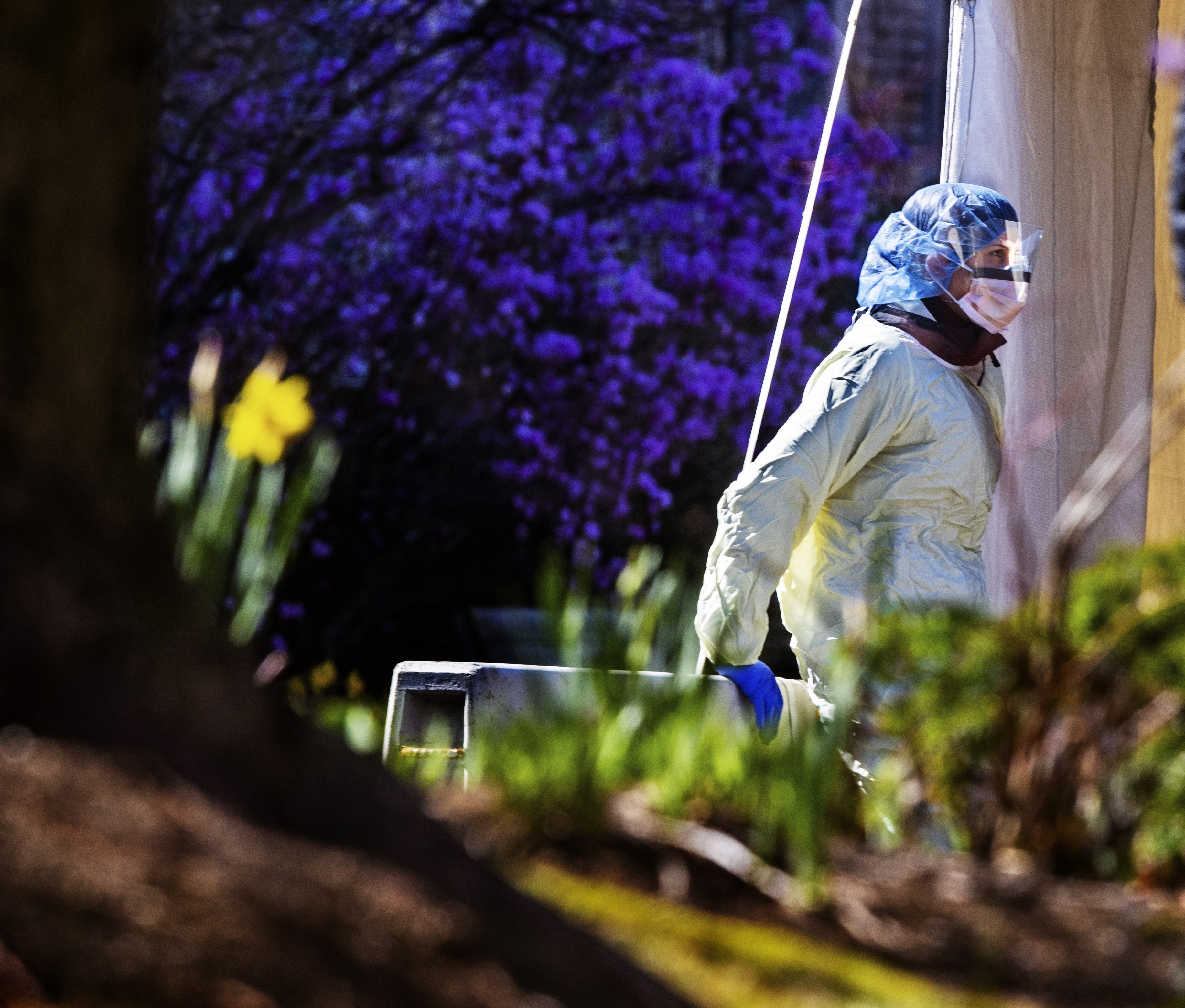 Boston, Ma April 7,  2020 - A health care worker grabs a moment in the sunshine at a coronavirus testing site outside Beth Israel Deaconness Medical Center. (Stan Grossfeld/Globe Staff)