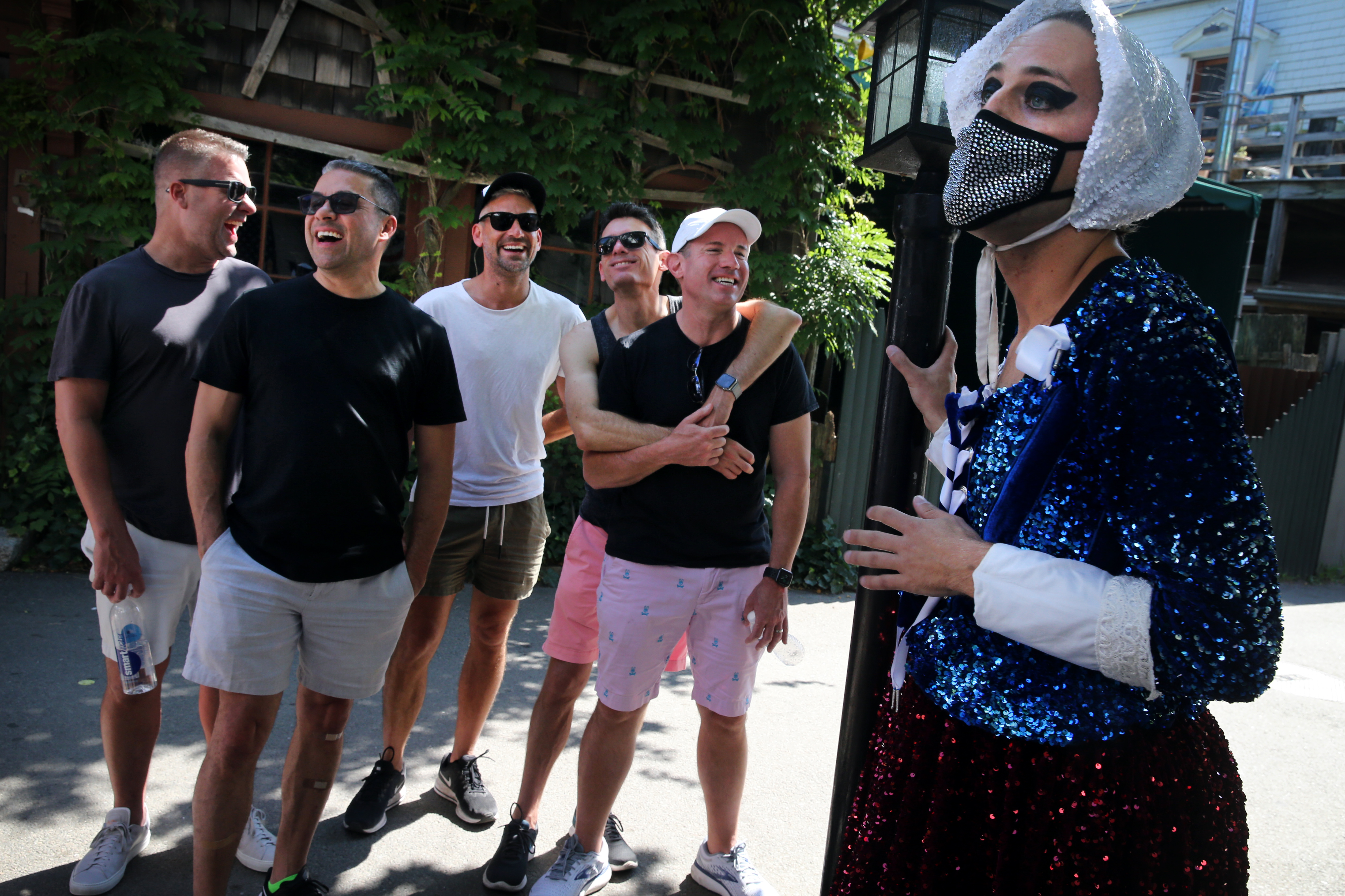 Brent Thomas, dressed as historic figure Anne Hutchinson, led a tour through Provincetown on Saturday. Thomas said they limit their tour to 10 people and asks that they practice pandemic protocol. This group confirmed they had all been vaccinated.