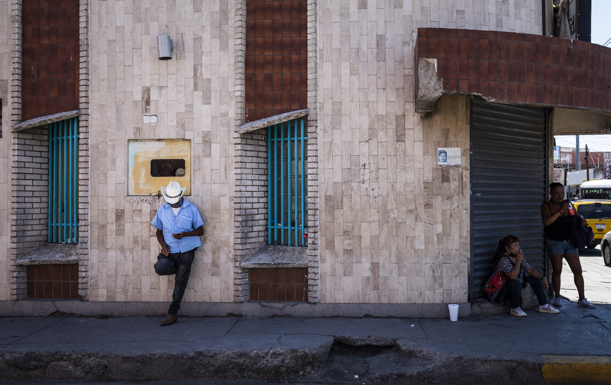 A man leaned against a wall in Juarez, Mexico. Bordering El Paso, Juarez has been at the front of border patrol and immigration conversations during the Trump administration.