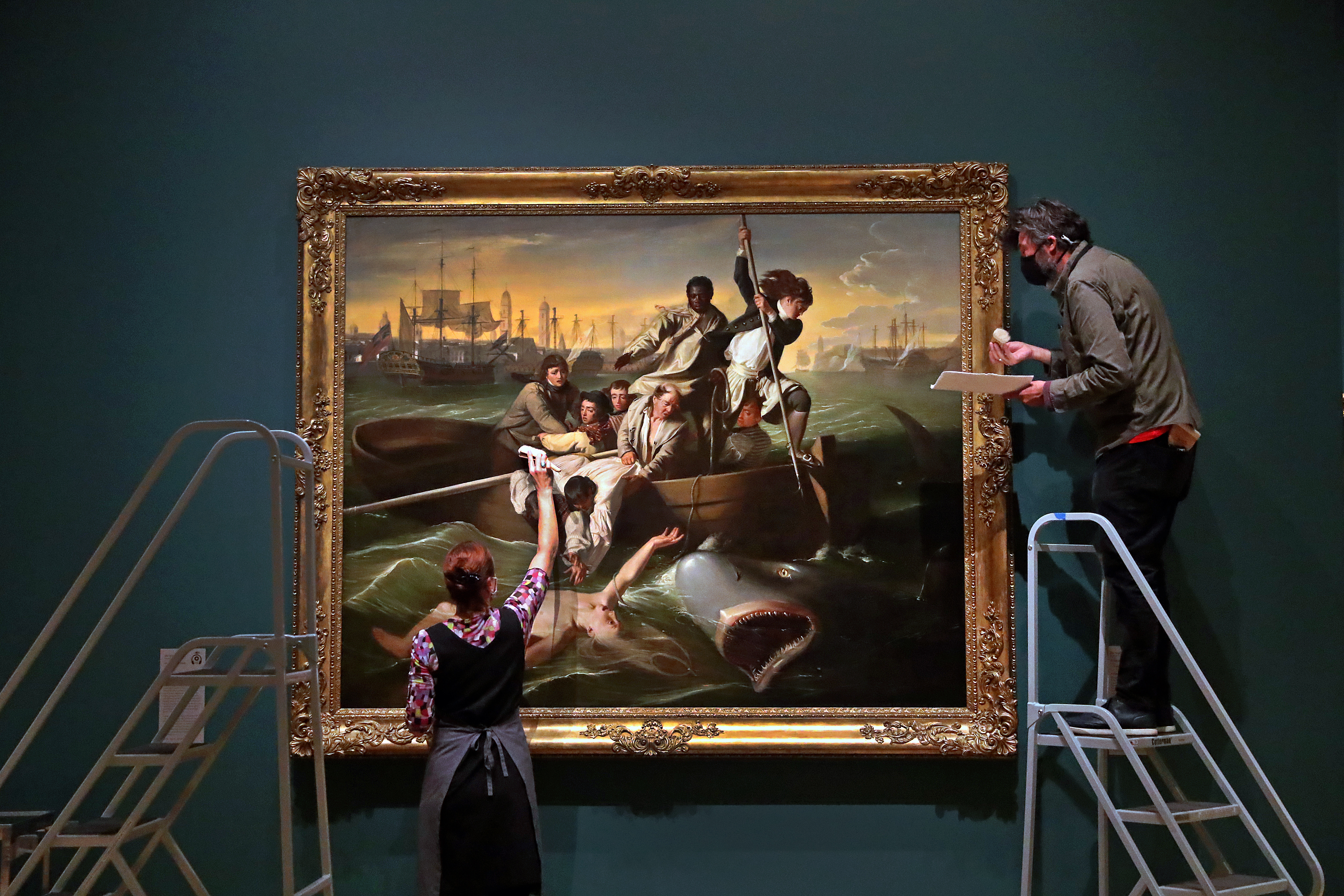 Painting conservator Charlotte Ameringer, left, worked with collections care specialist Gregg Porter on John Singleton Copley's "Watson and The Shark" from 1778. The painting can be viewed in the Art of the Americas Wing, due to reopen Sept. 26.