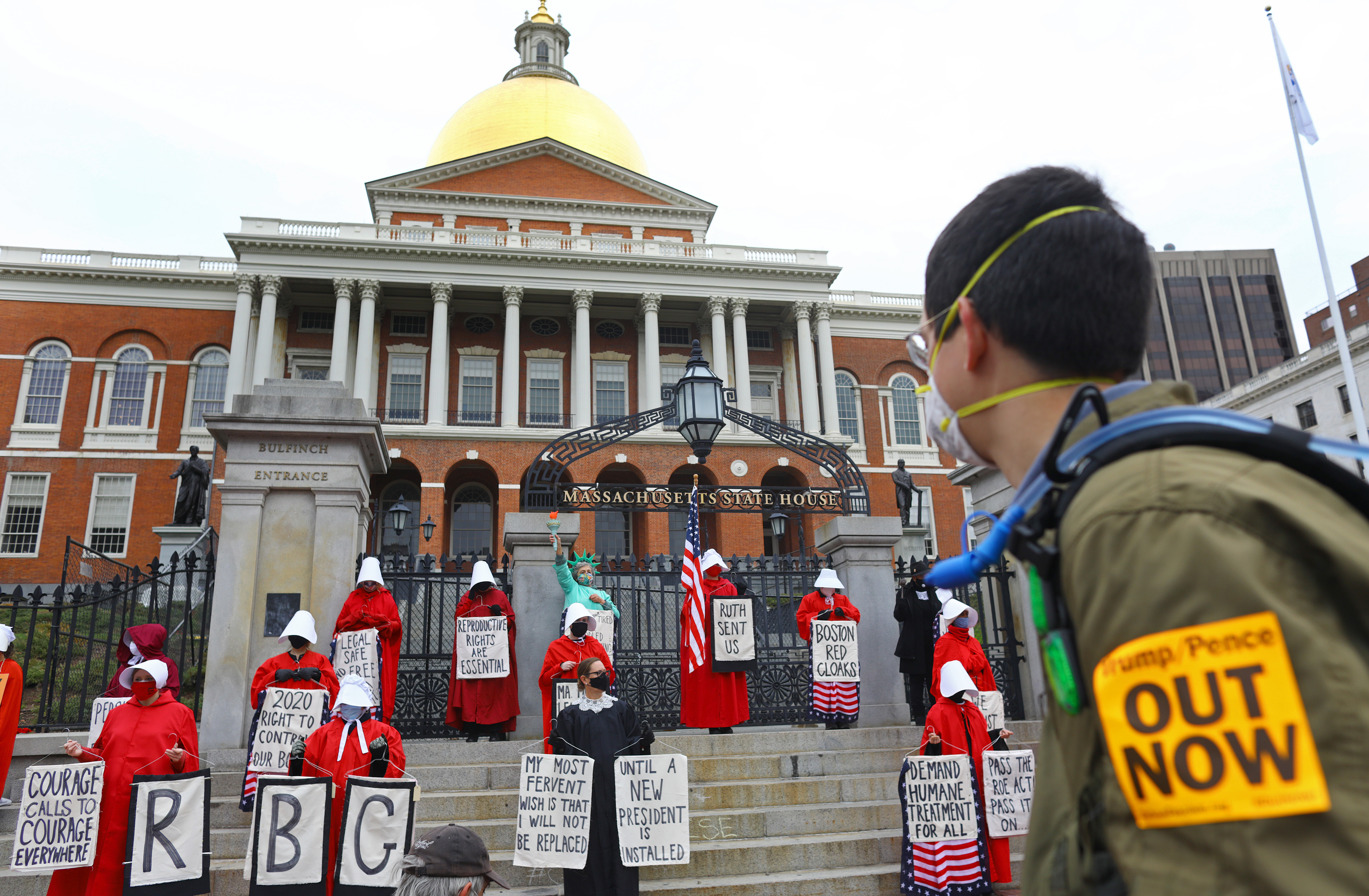 A group of about two dozen were dressed as justices, suffragettes, and the Statue of Liberty, with the majority clad in red cloaks and white bonnets, a nod to Margaret Atwood’s novel “The Handmaid’s Tale," which depicts a misogynistic dystopia.