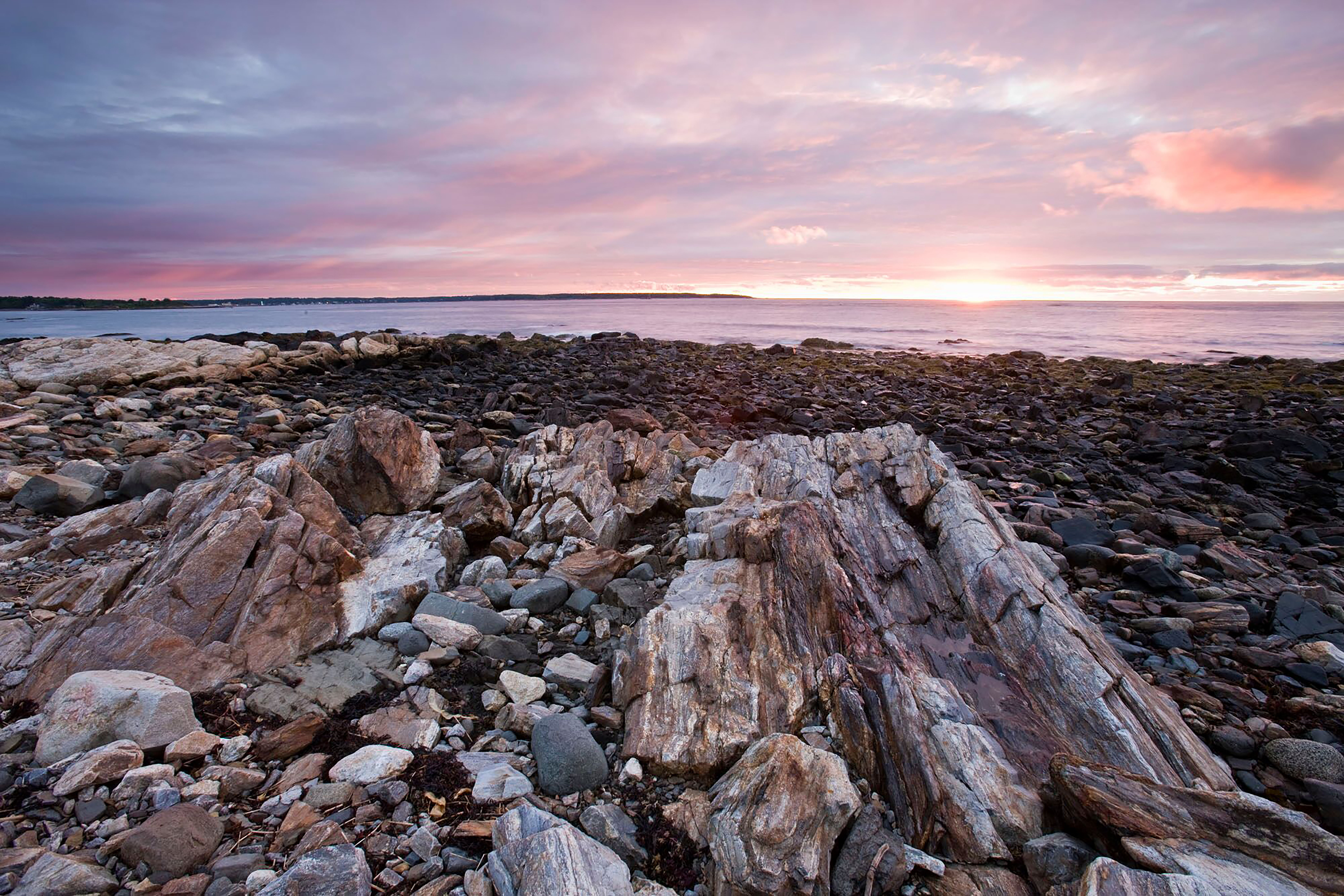 There are beautiful sky views along the rocky shoreline at Odiorne State Park.