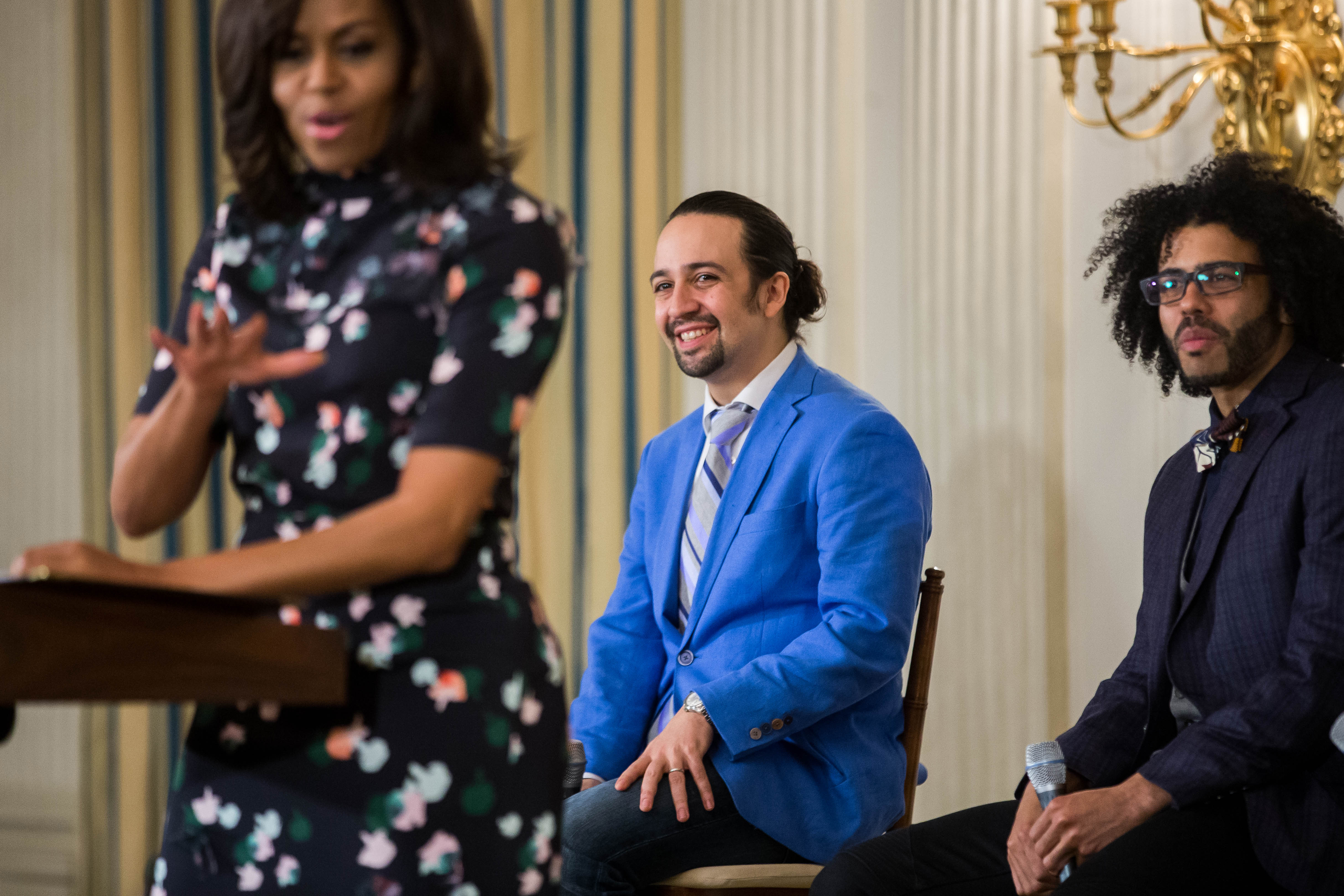 Lin-Manuel Miranda, center, listened as first lady Michelle Obama spoke during an event with the cast of "Hamilton" at the White House in 2016. Seven years earlier, Miranda debuted what would become the opening number from his still-in-development musical for the Obamas.