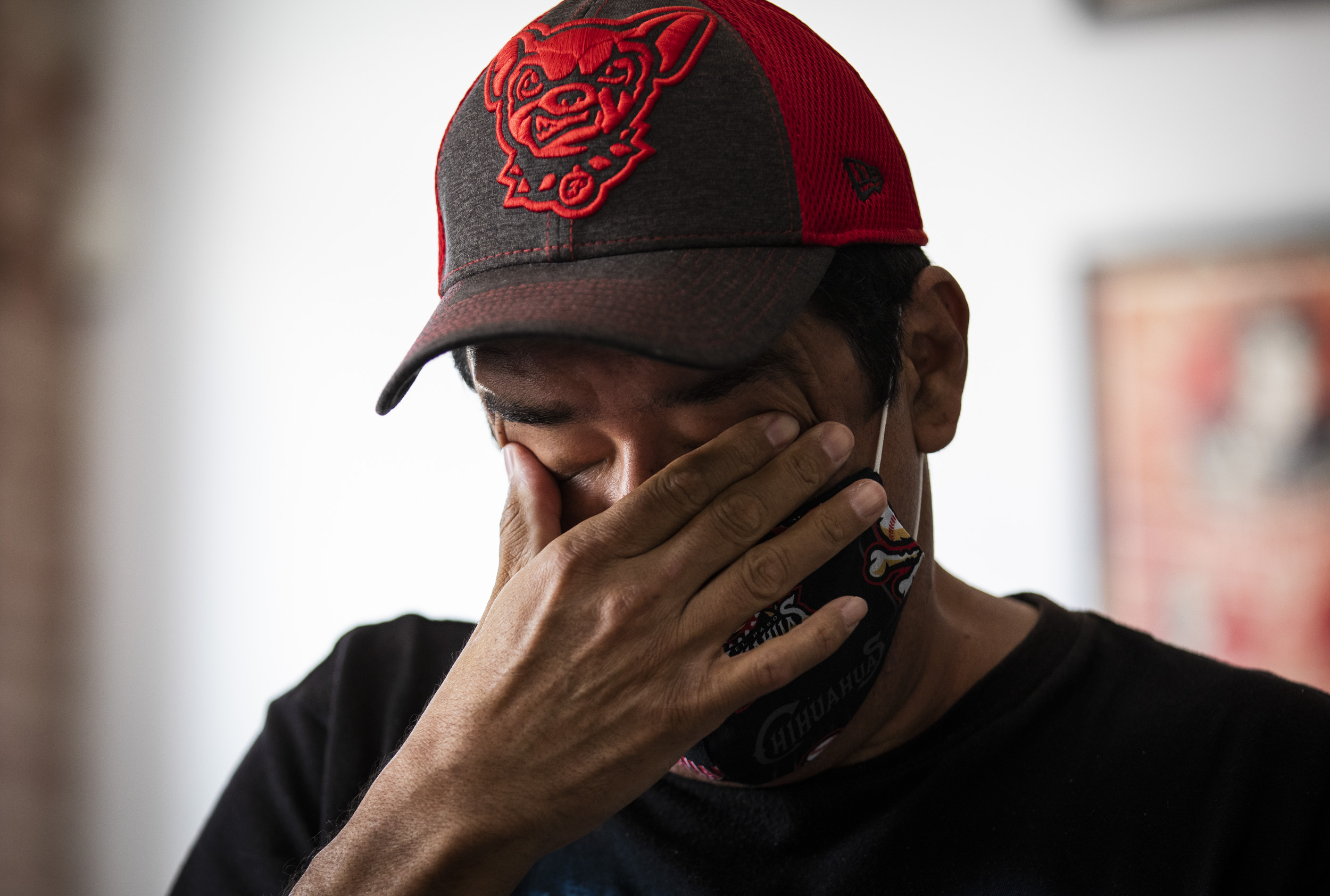 Photojournalist Armando Vela wiped tears from his eyes while remembering the Walmart shooting.