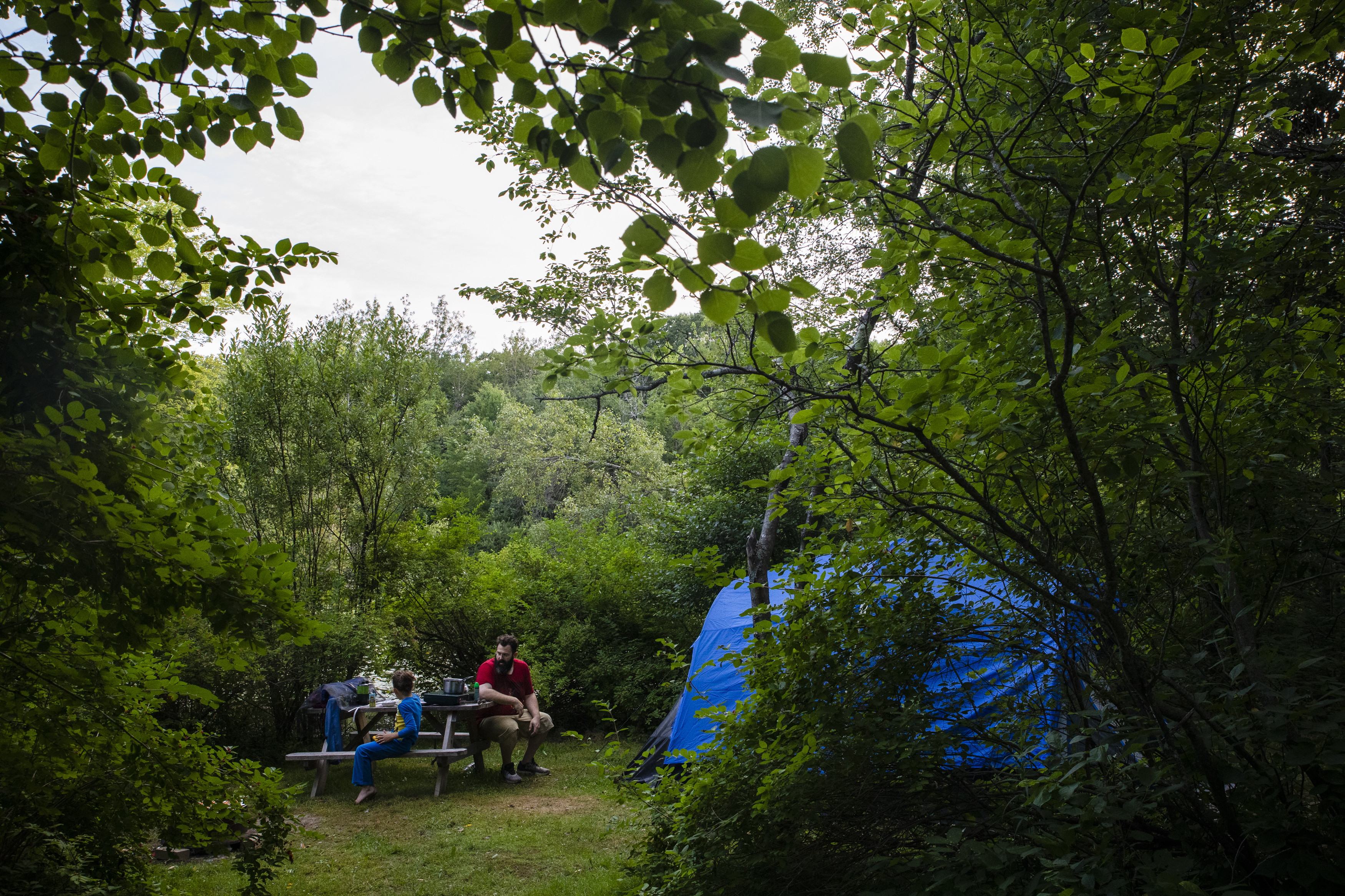 Patrick Lupien sits with his son Evan at their campsite while Laya and Dylan watch movies in the van. With the children’s special needs, Mariah and Patrick have found it difficult to keep an eye on them while living in the campground. Surrounded by a pond and dense forest, the couple has to be abundantly cautious to ensure the children do not wander off.