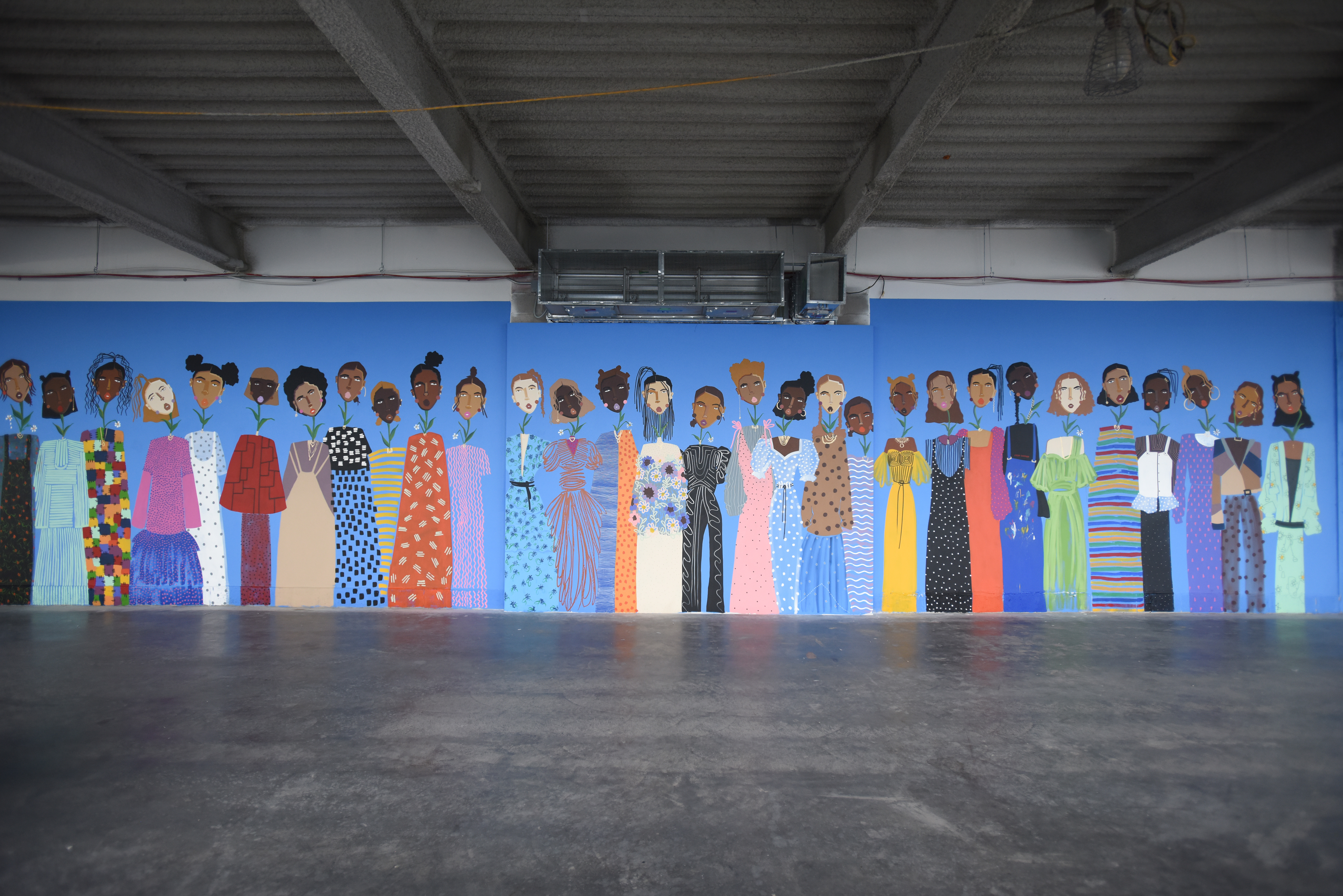 Artist Cristina Martinez's 52-foot-long mural of Black and brown women, a sisterhood of resilience, growth, and the future, at 3 World Trade Center, on the 79th Floor in Manhattan.