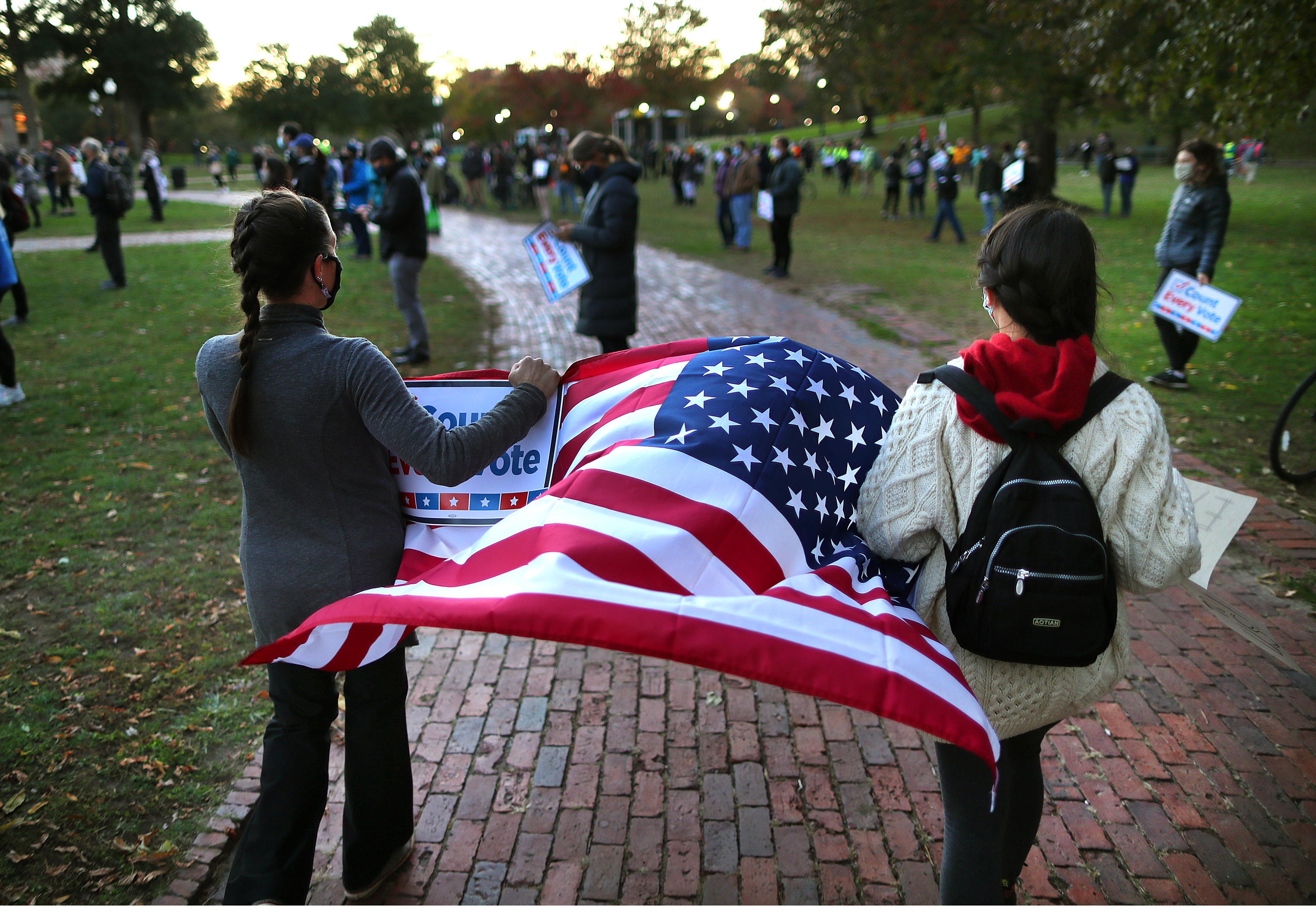 Two women carried an American flag through the rally.