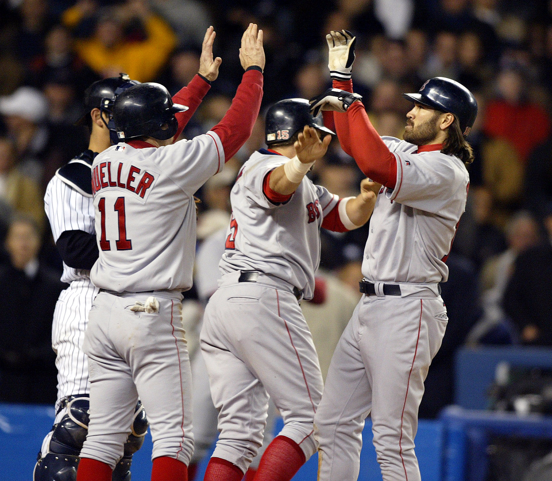 Johnny Damon (right) is congratulated after his grand slam against the Yankees in Game 7 in 2004.