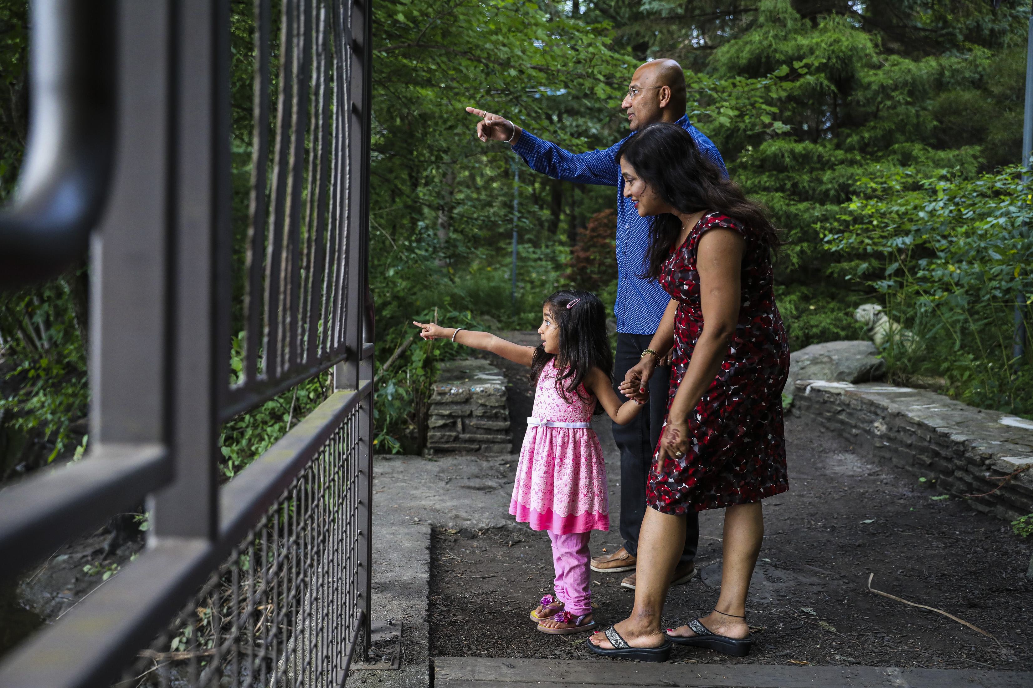 Jagan Srinivasan looked for wildlife with his wife, Snehalata Kadam, and daughter Uruvi, 3, while they explored a nature trail near their Shrewsbury home on Wednesday evening.