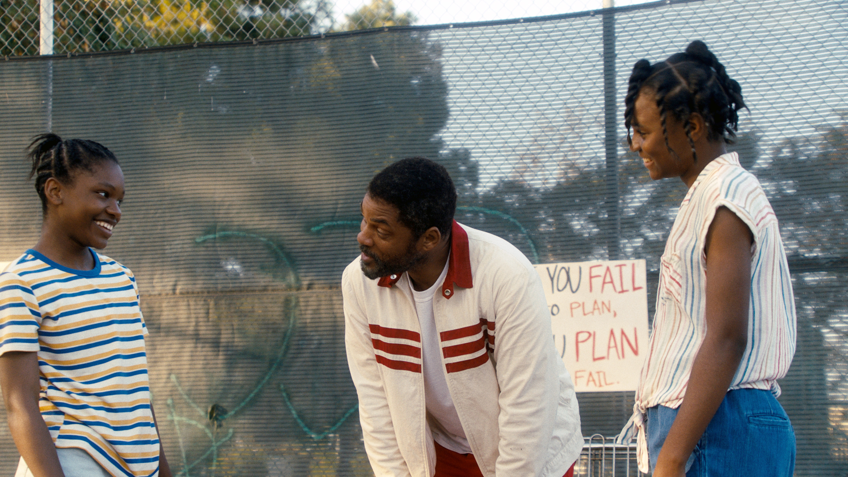 Will Smith, center, with Demi Singleton, left, and Saniyya Sidney in "King Richard."