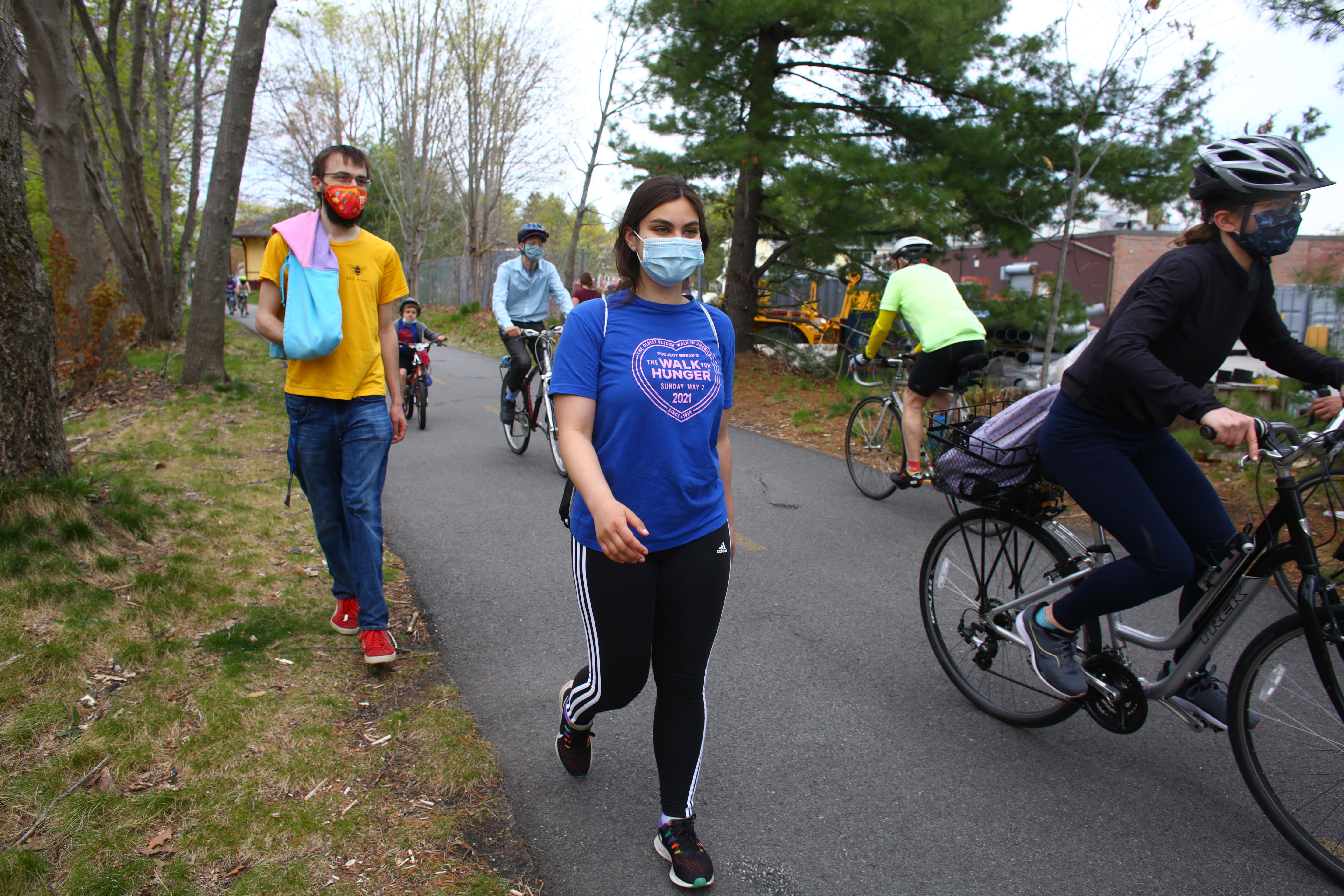 Accompanied on part of her journey by friend Jonas Vandebroek (left), Saadia Ali walked along the Minuteman Commuter Bikeway in Bedford.