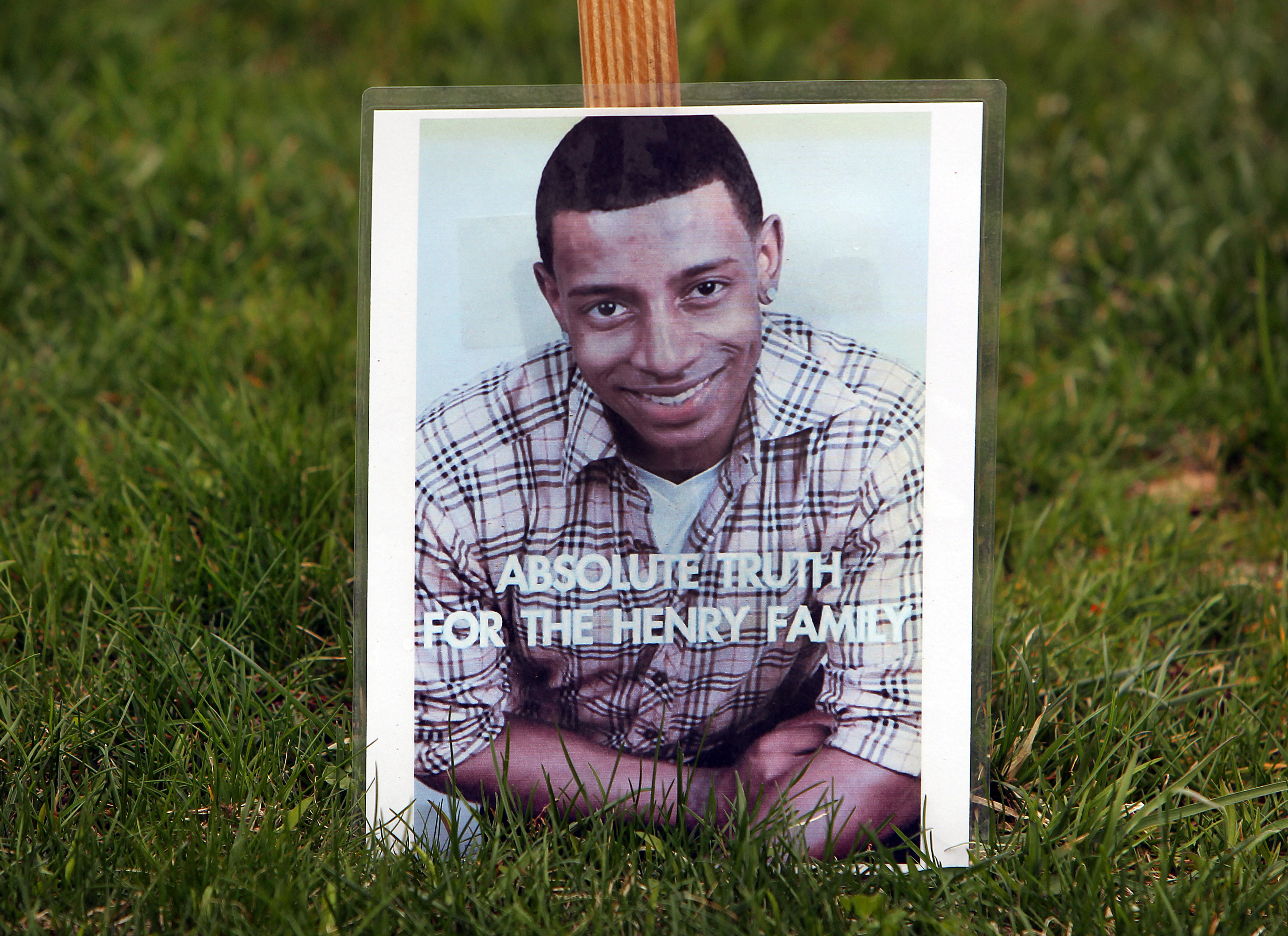 The family of slain Pace University student, Danroy D.J. Henry from Easton, has settled a lawsuit against the police officer who fired the fatal bullets and his department. There are many signs like this on the street his family lives on in Easton.
