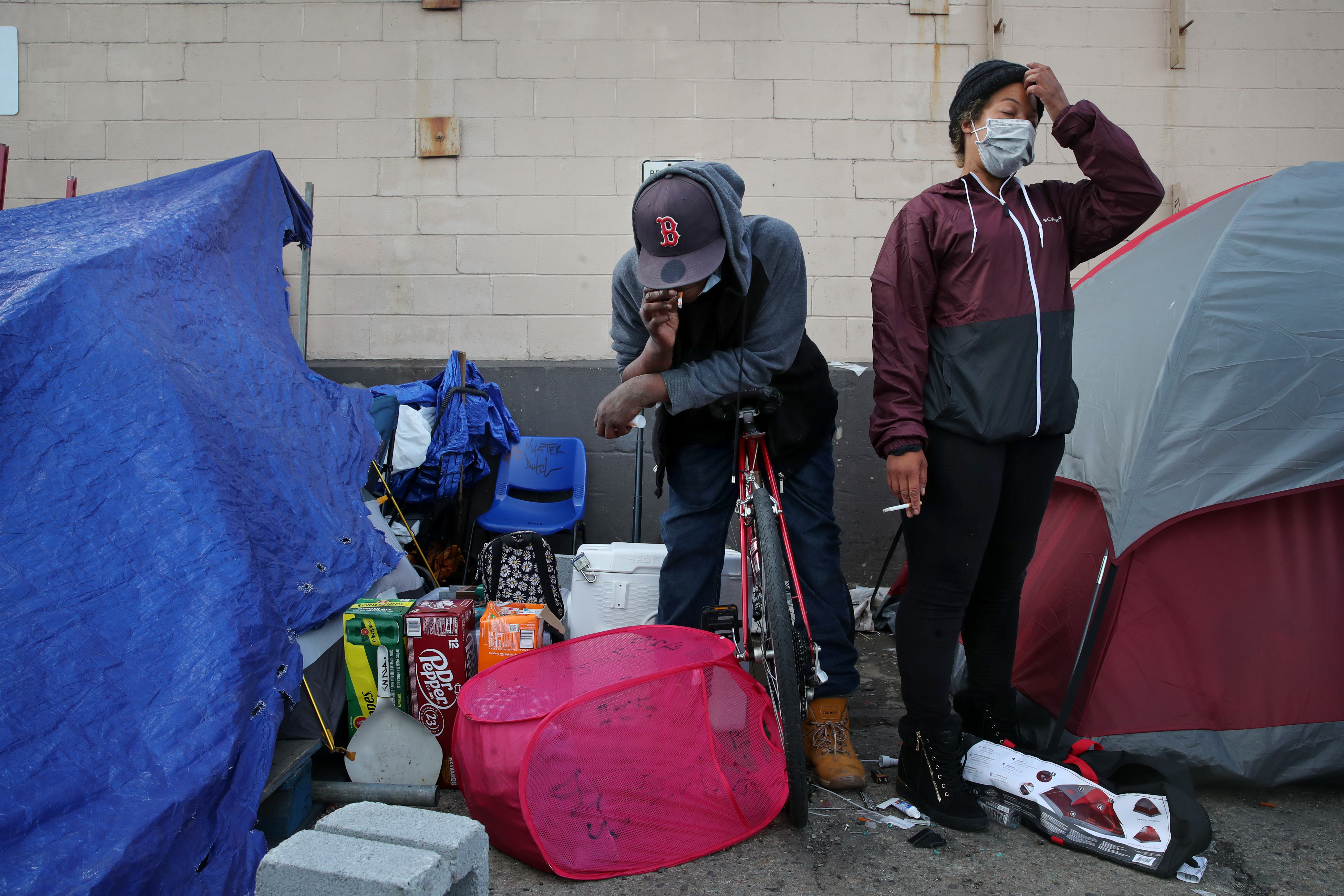 Kitti Malone (right) and her partner, Jay, stood outside their tent on Topeka Street.