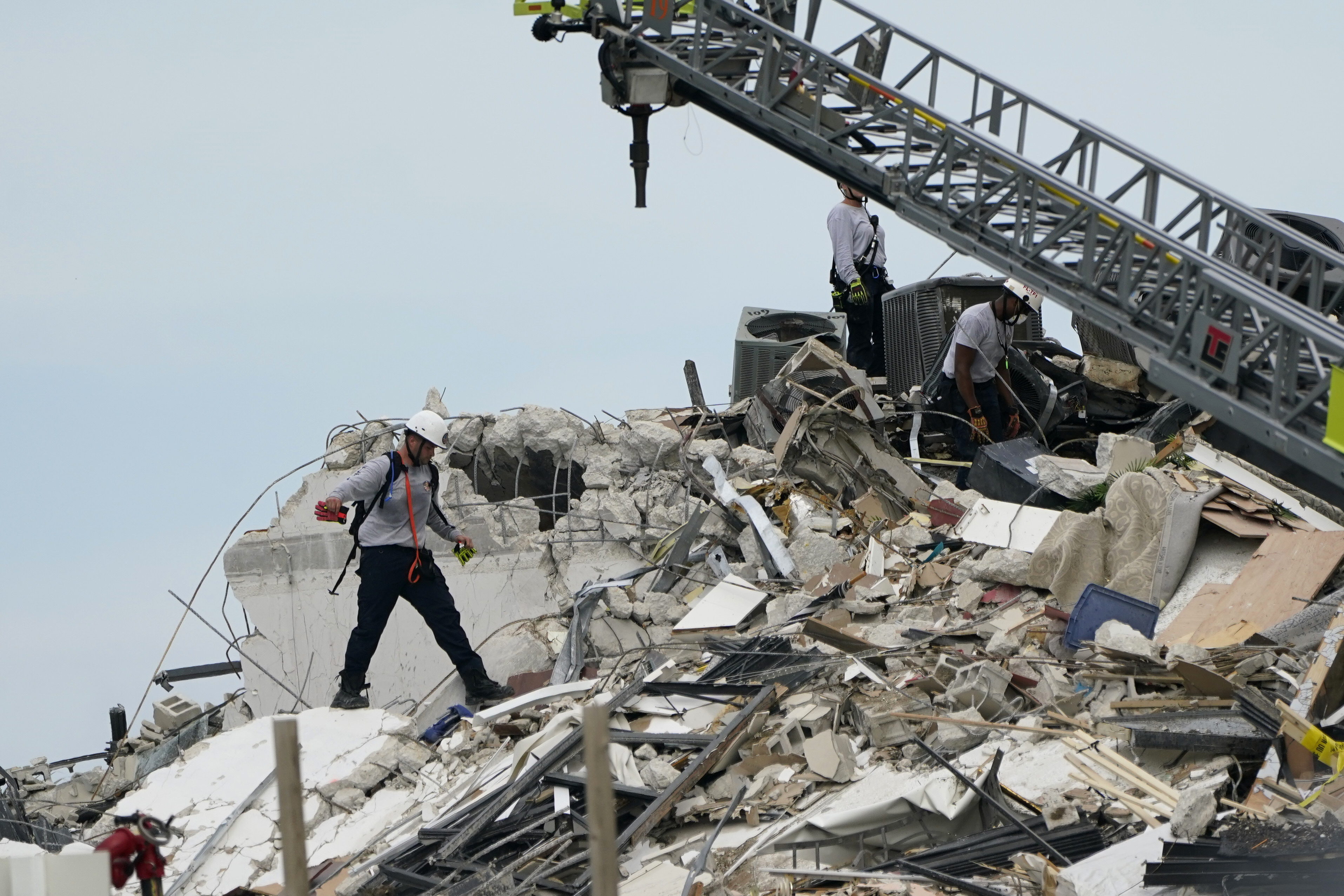 A rescue worker walks among the rubble.