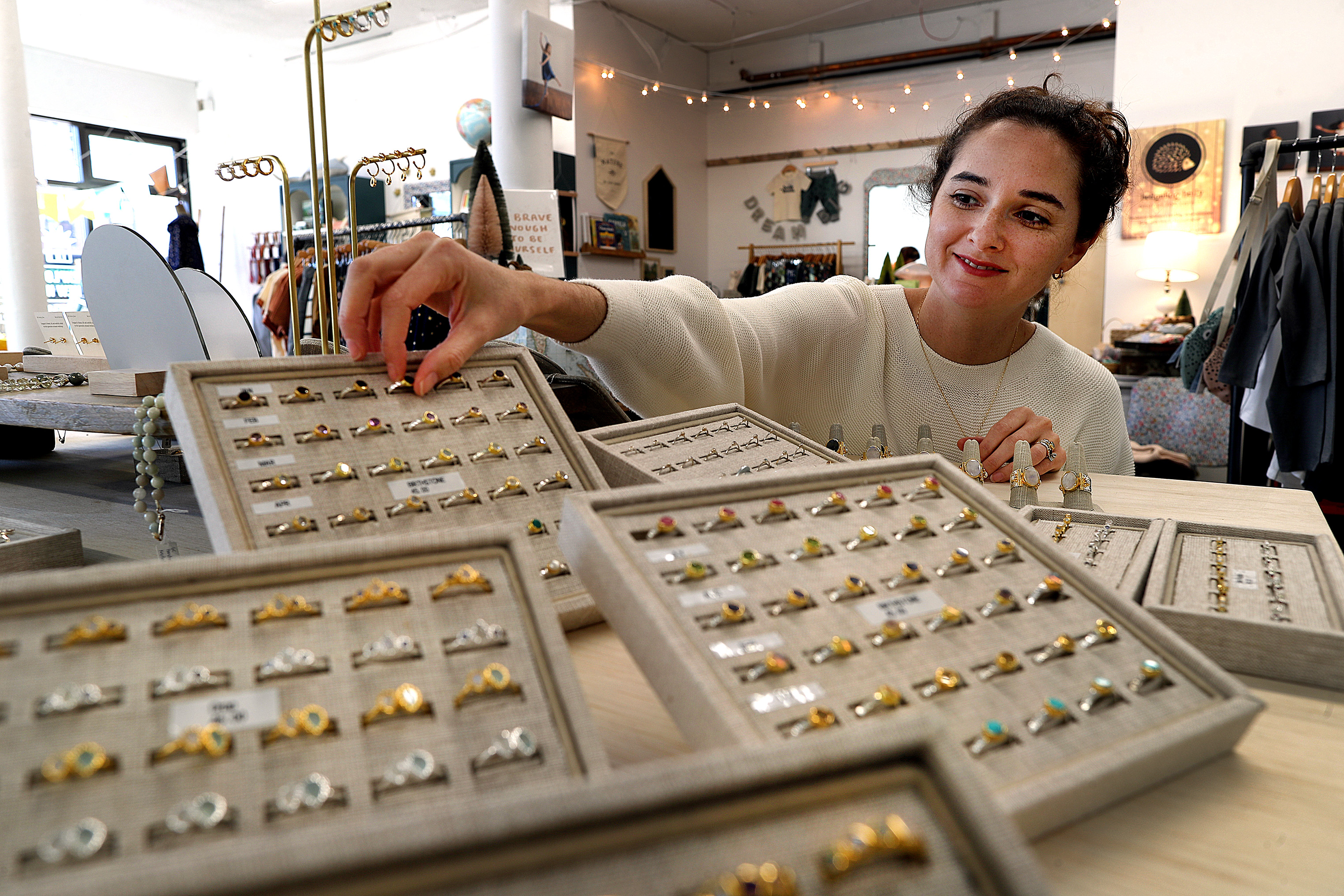 Cristina Garcia arranges rings in her pop-up boutique in Newton Highlands. 