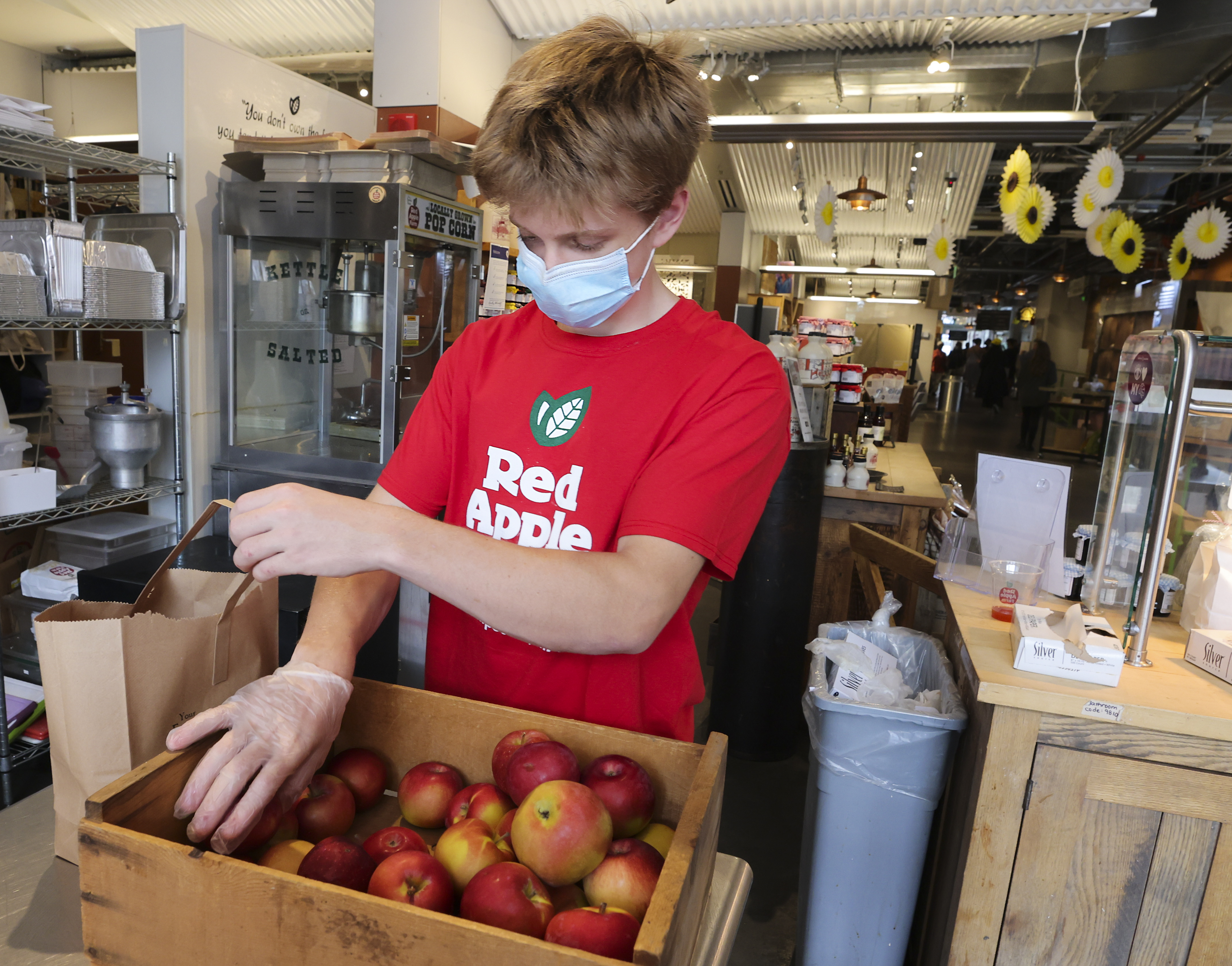 Graham Owens, an employee at Red Apple Farm's, loads a bag of imperfect apples.