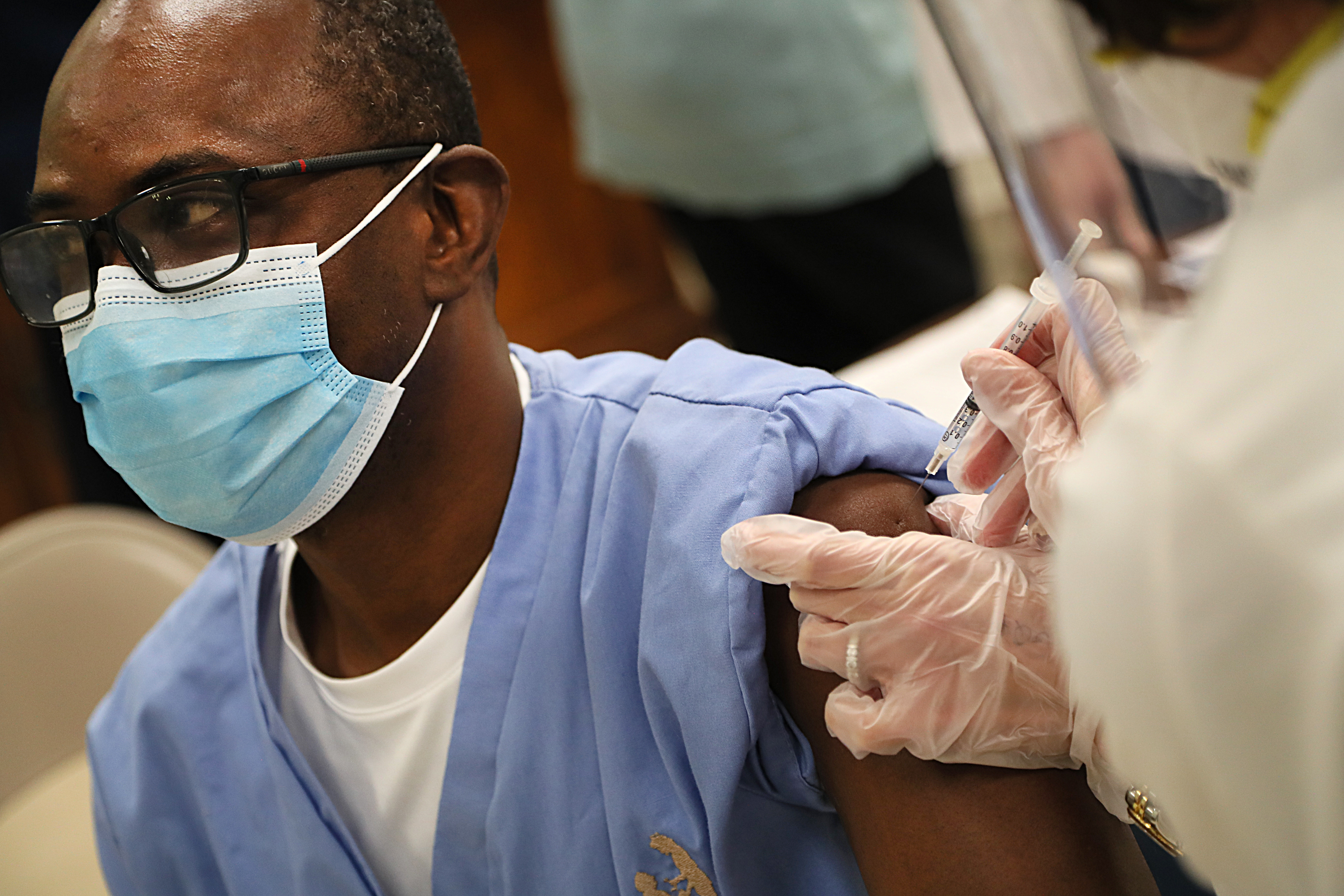 Nurse Malick Issah had the coronavirus and was one of the first to get the Pfizer COVID-19 vaccine at Life Care of Acton on Monday.