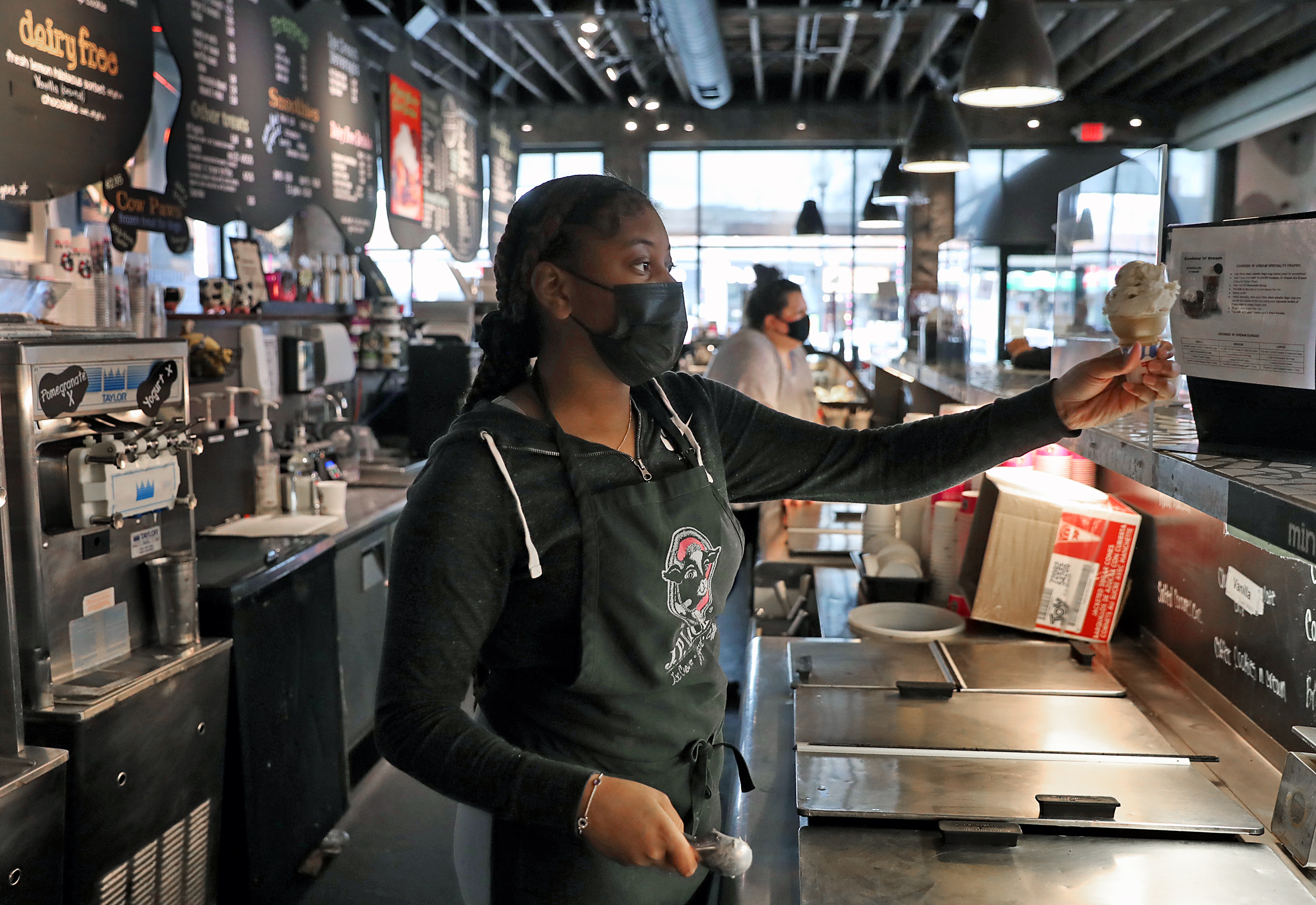 J.P. Lick's employee Alea Turner served ice cream to a customer.