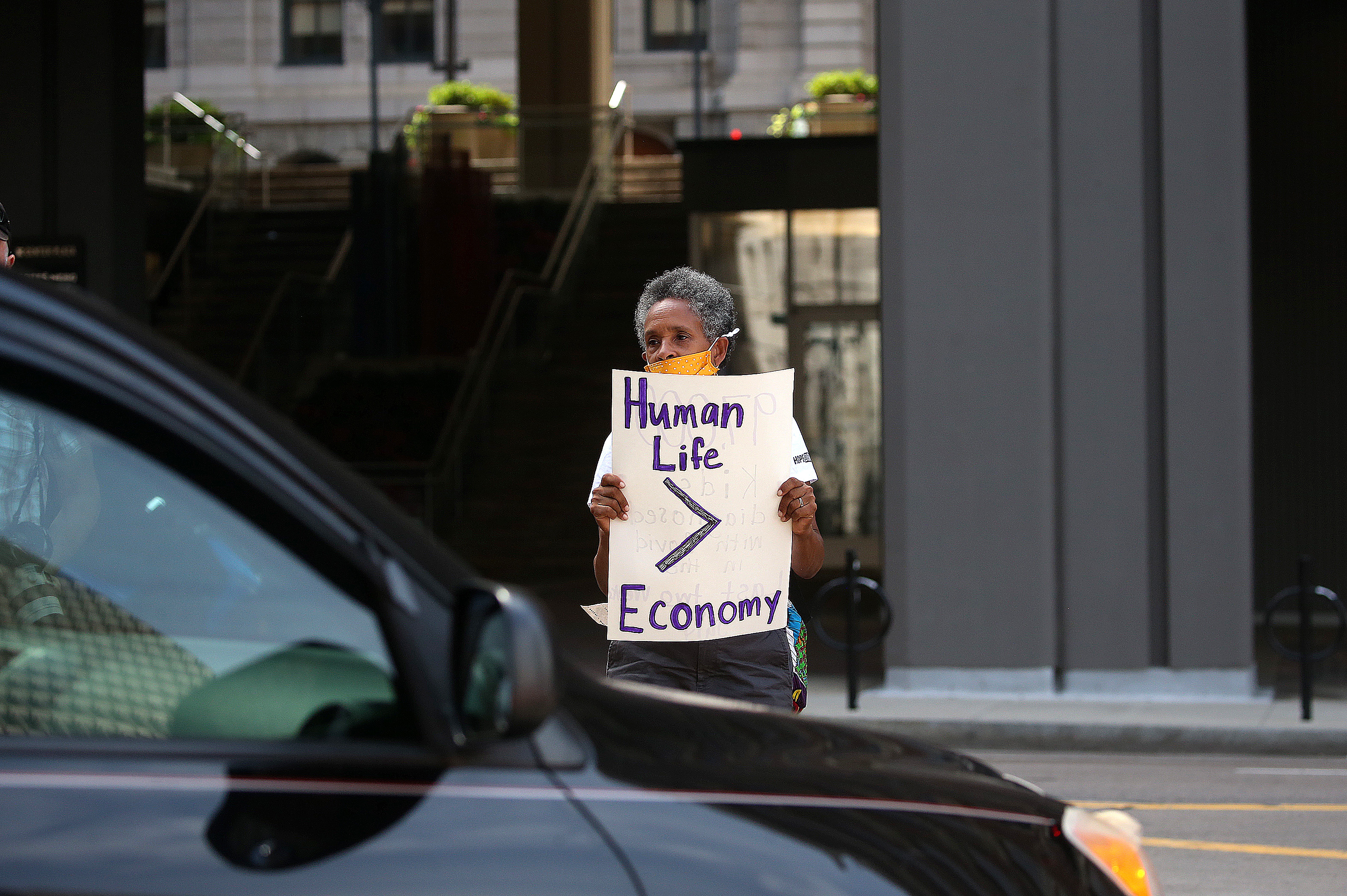 Cynthia Grant Carter, a third grade teacher at the Patrick J. Kennedy Elementary School in East Boston, held up a sign as a BTU Caravan wound past City Hall.