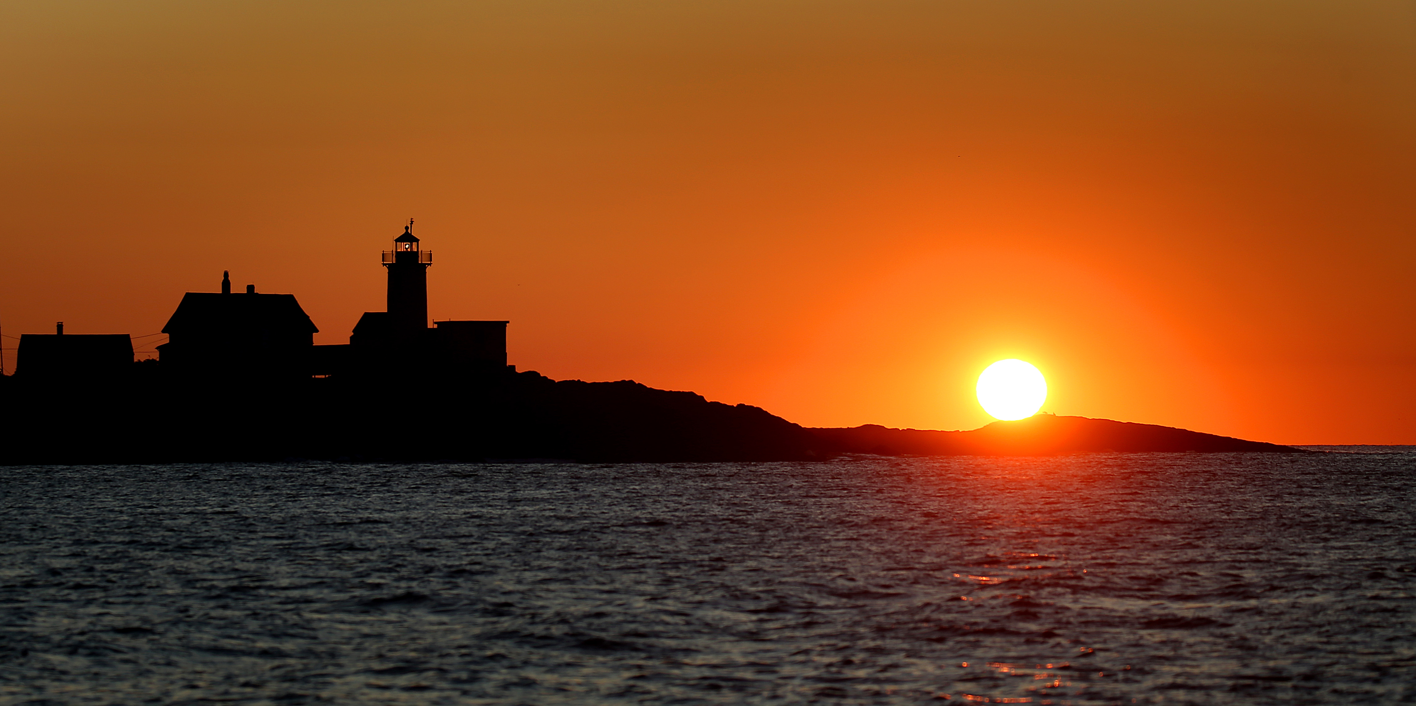 A golden sunrise by the Eastern Point lighthouse in Gloucester on Sept. 17.
