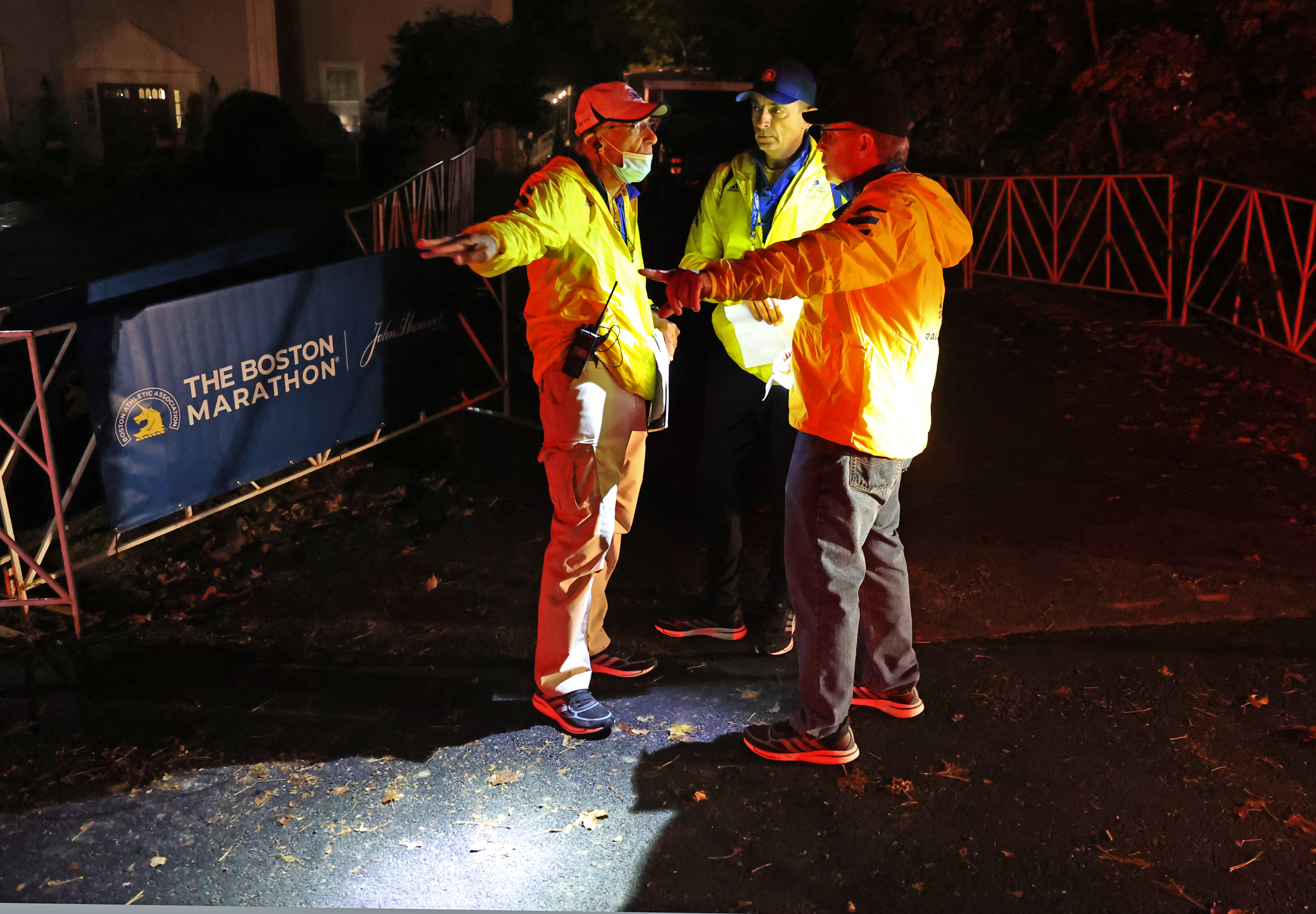 Before dawn, race officials discuss plans down at the start line in Hopkinton.