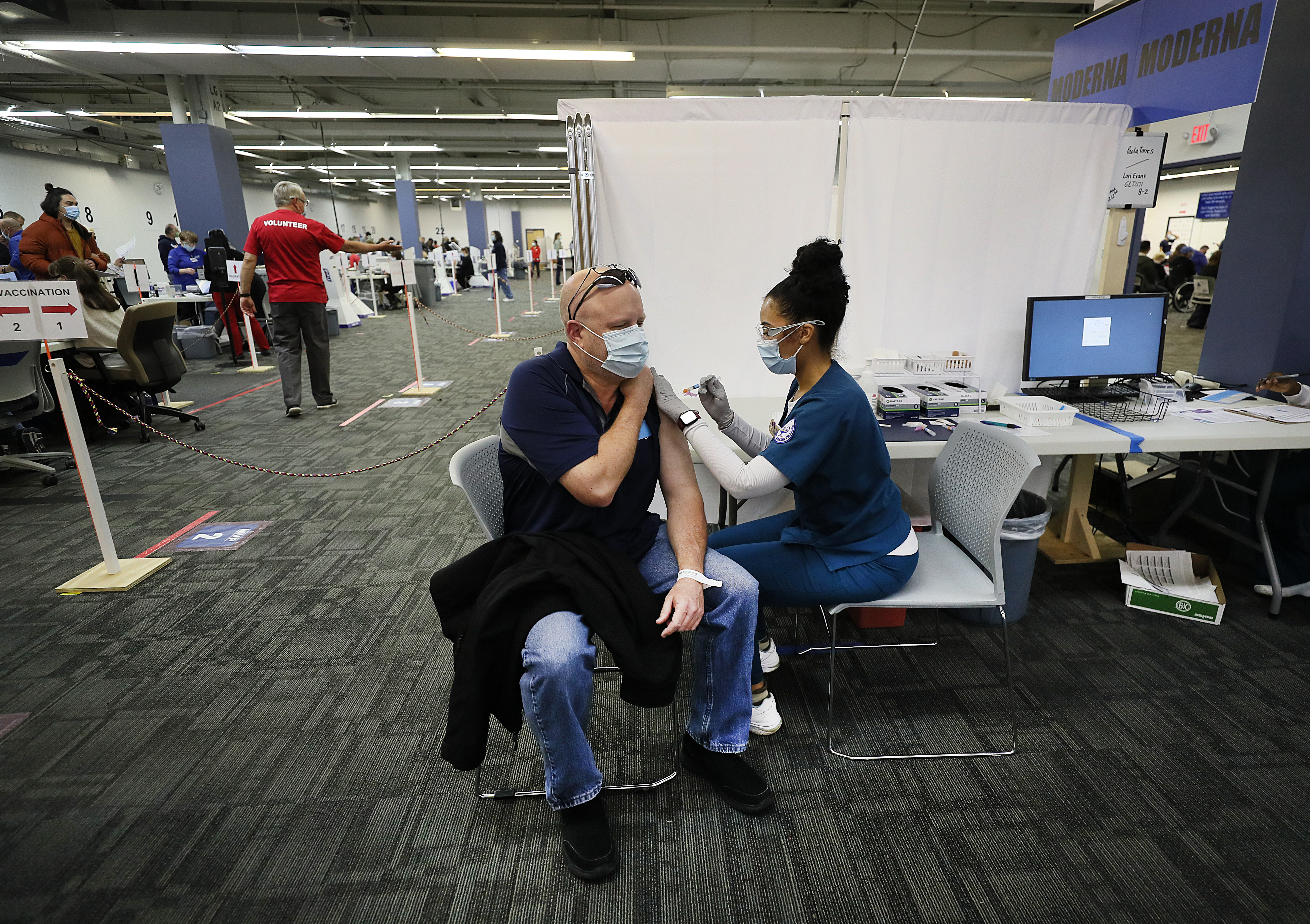Scott McIsaac received his vaccination from nursing student Danelly Pimentel at the Cross River Center by Lowell General Hospital.