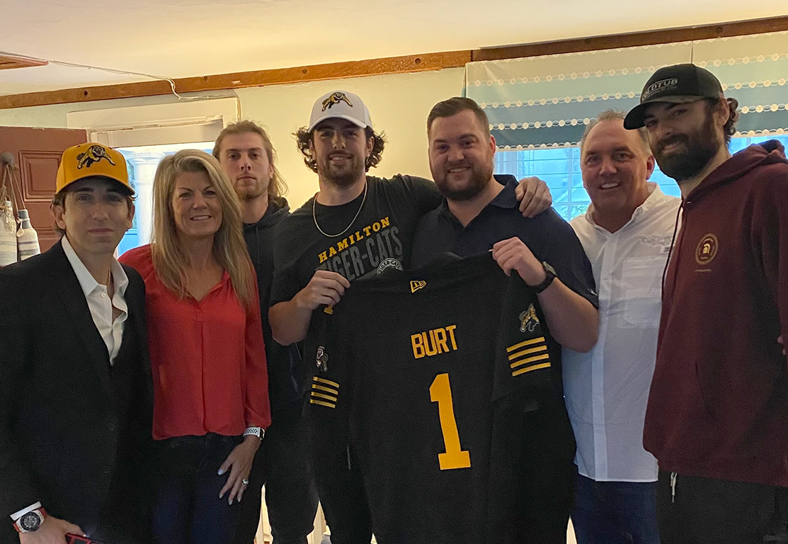 Jake Burt (fourth from left) and his family celebrate Burt being selected first overall in the CFL draft.