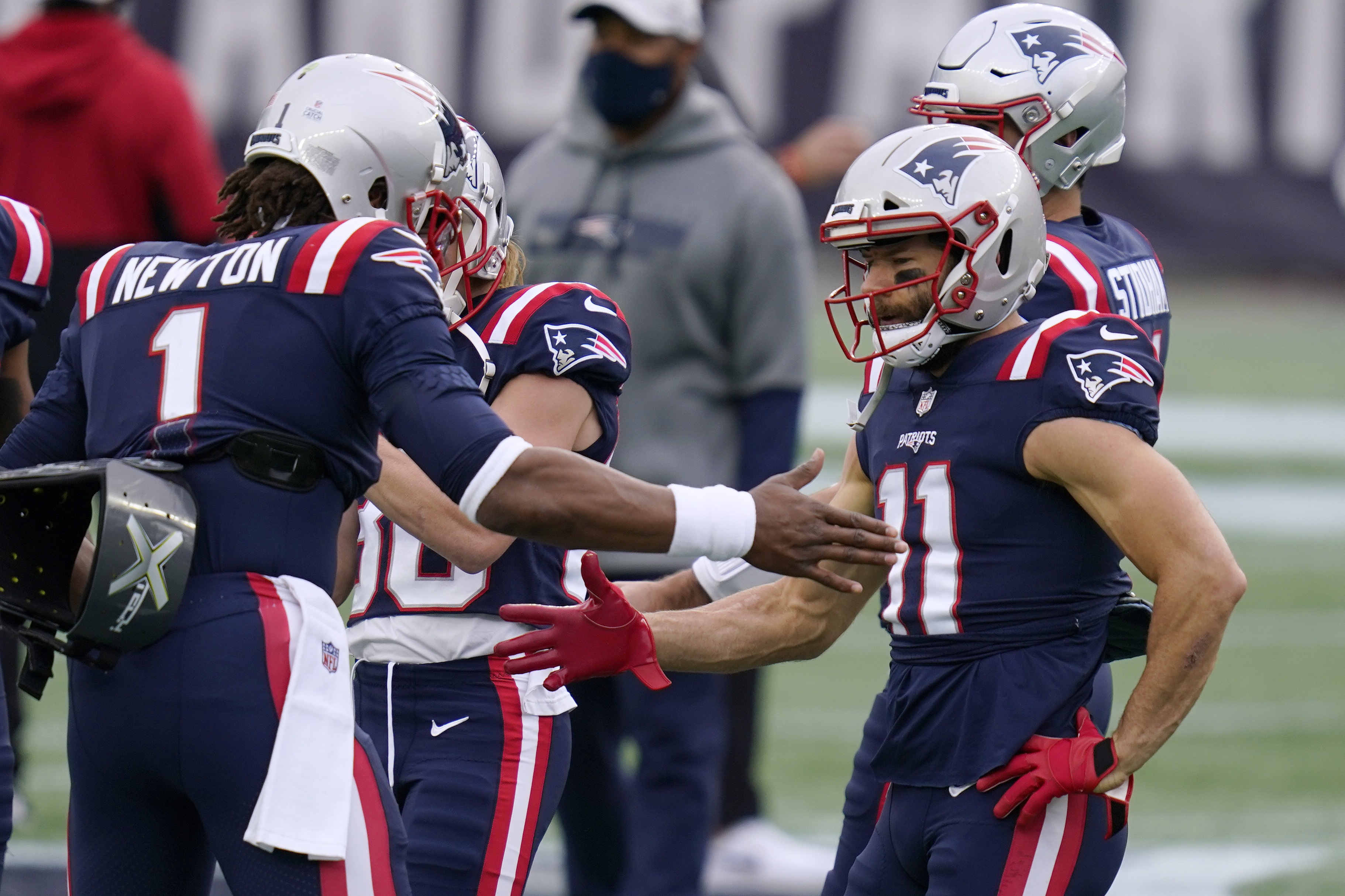 Cam Newton and Julian Edelman confer before the Niners' game.