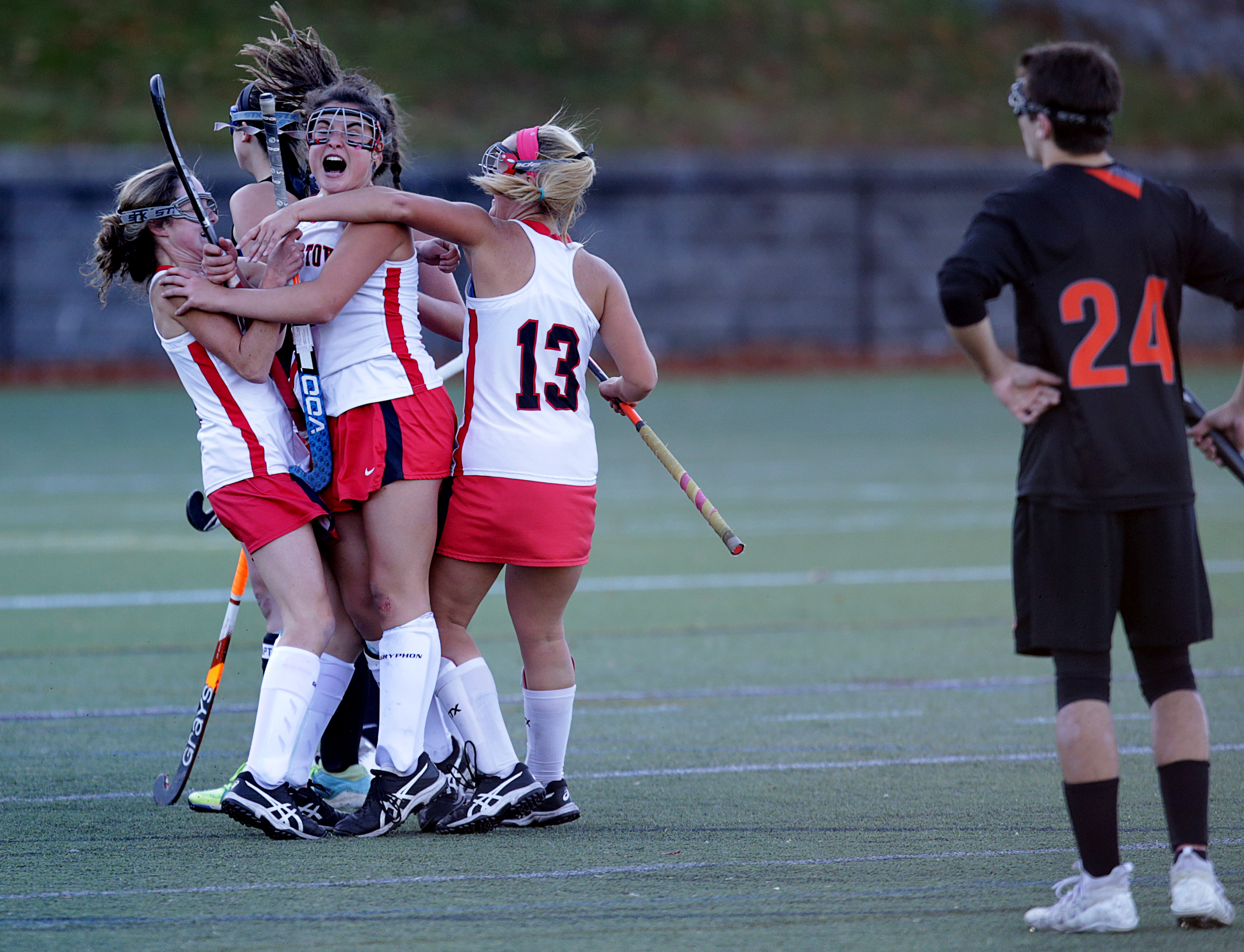 Watertown’s Elizabeth Loftus (middle) leaped for joy after scoring the winning goal in overtime in the quarterfinal Division 2 North Tournament game against Wayland on Nov. 2. Wayland’s Aiden Chitkara (right) looked on after the 1-0 loss.