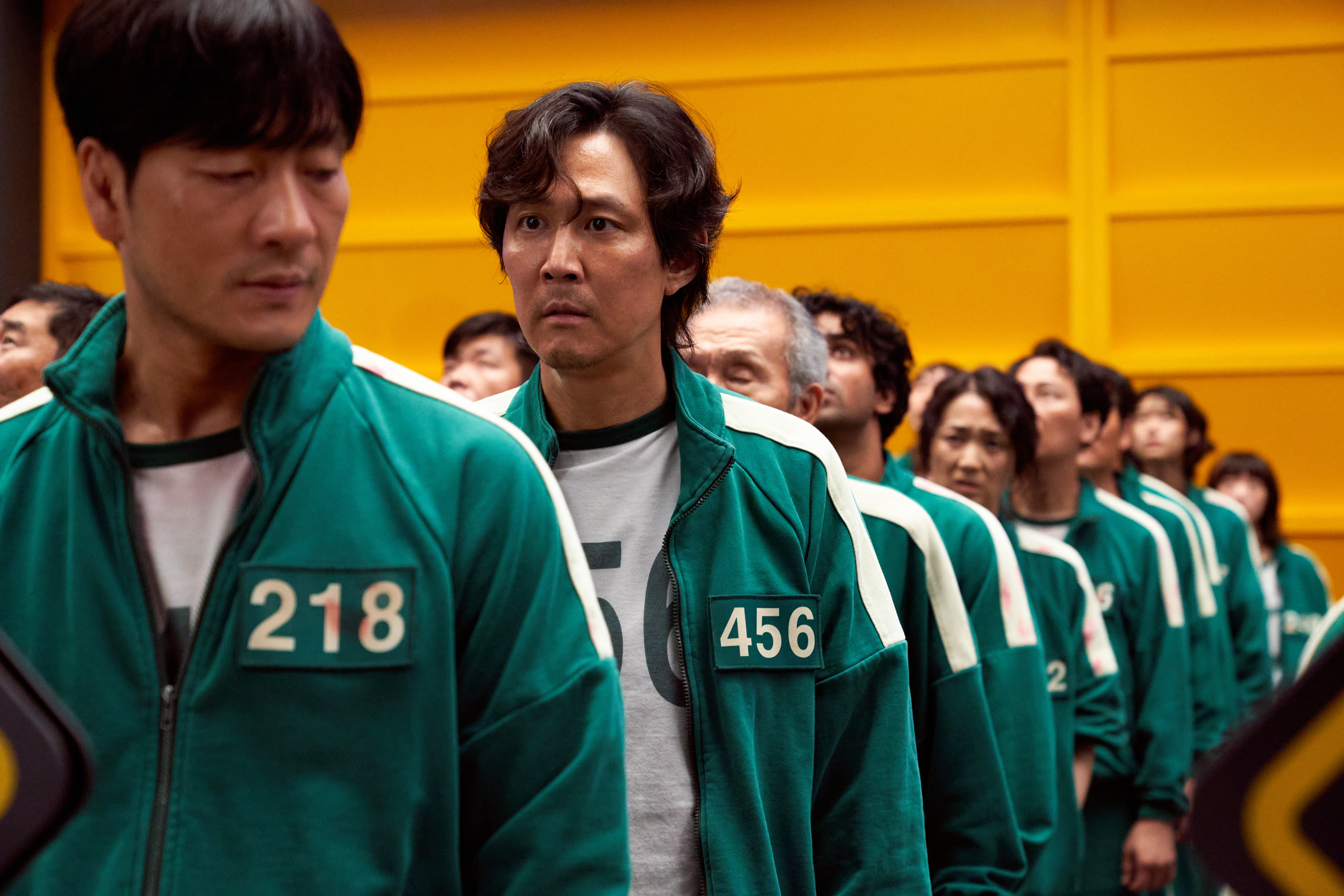 The character of Seong Gi-hun, donning the number 456, joins the deadly competition in "Squid Game" to pay off mounting debts.
