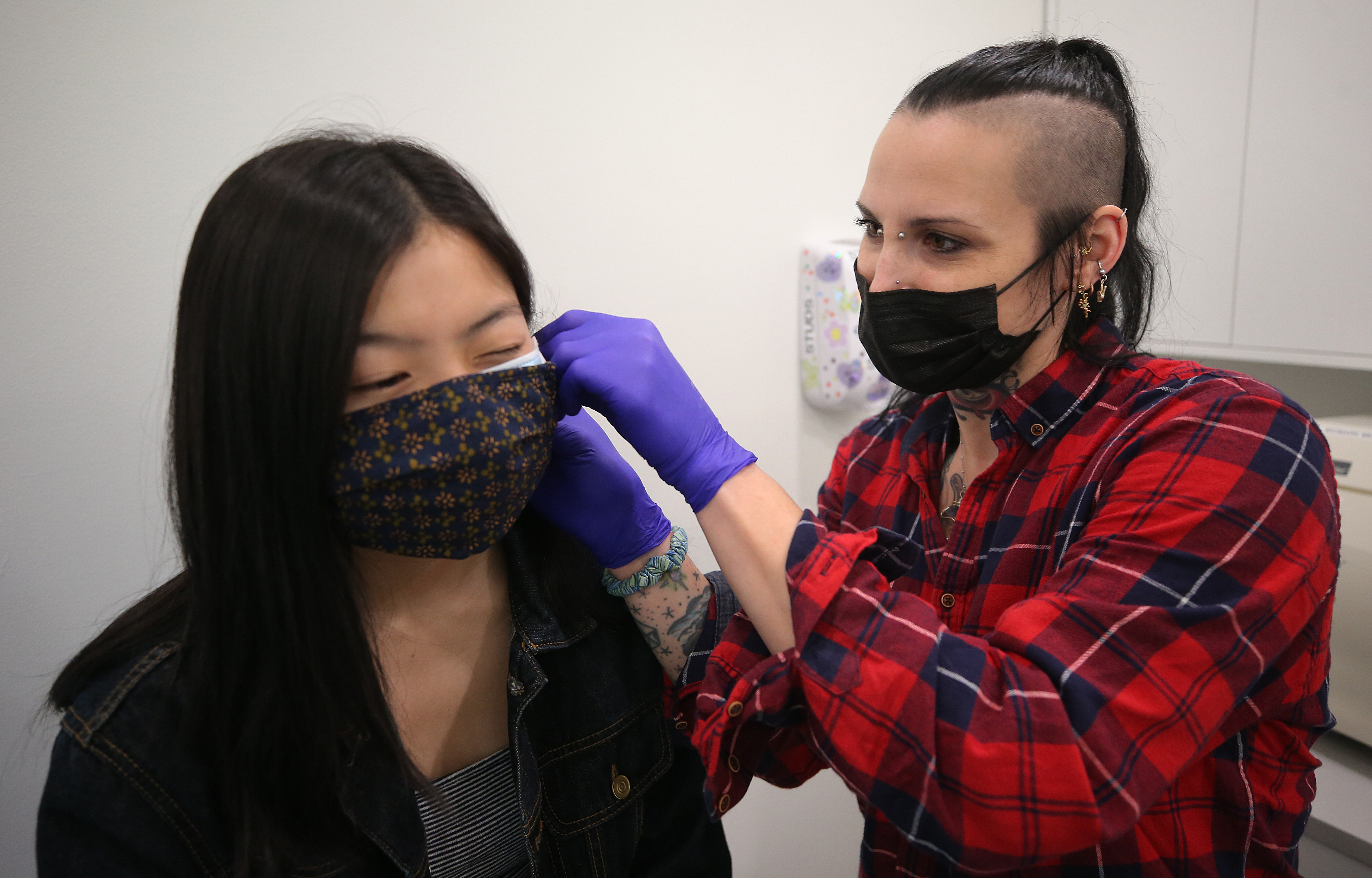 Customer Amber Chan got an ear piercing by employee Casey Danzig.
