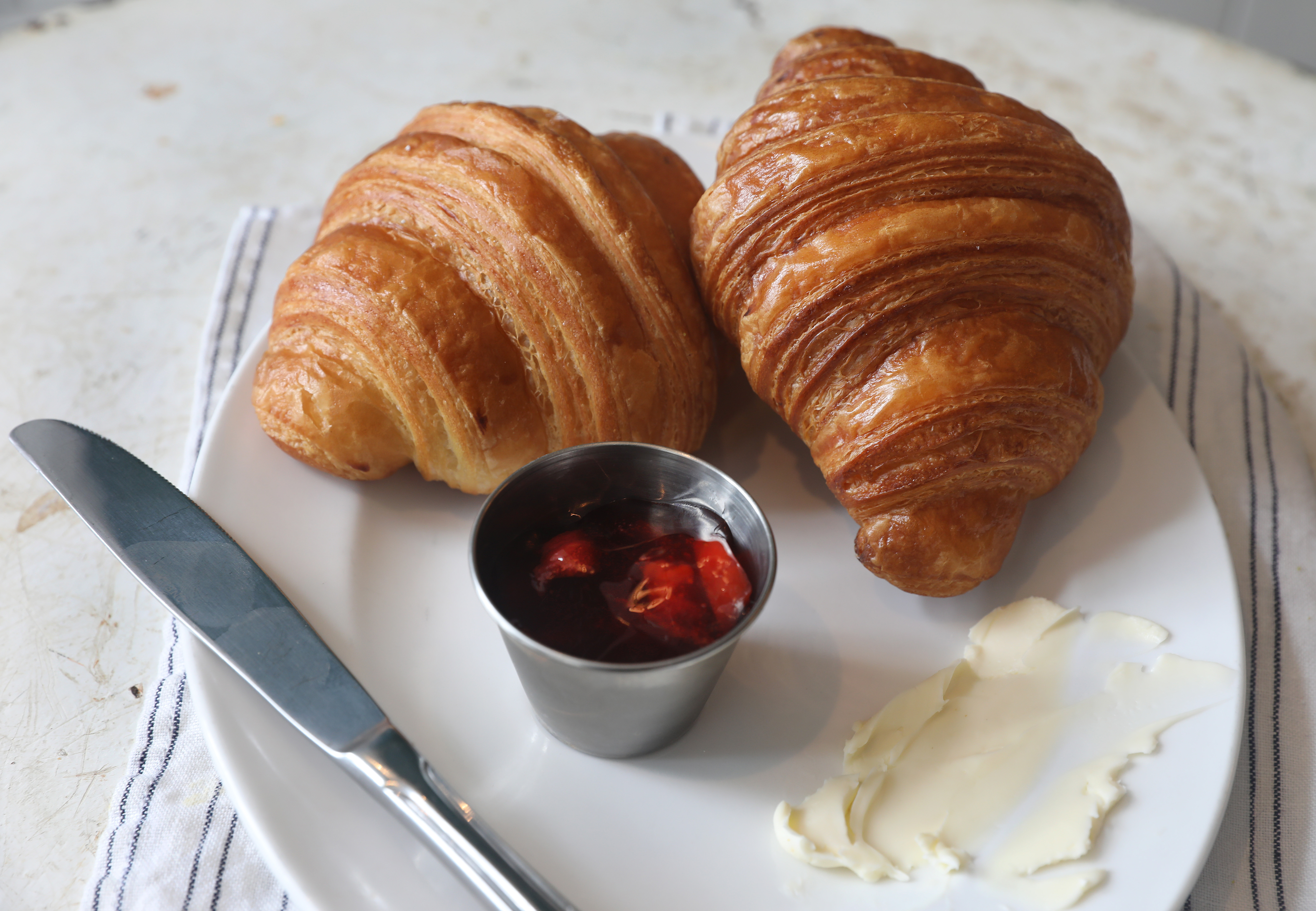 Plain croissant with strawberry jam and butter at Tatte