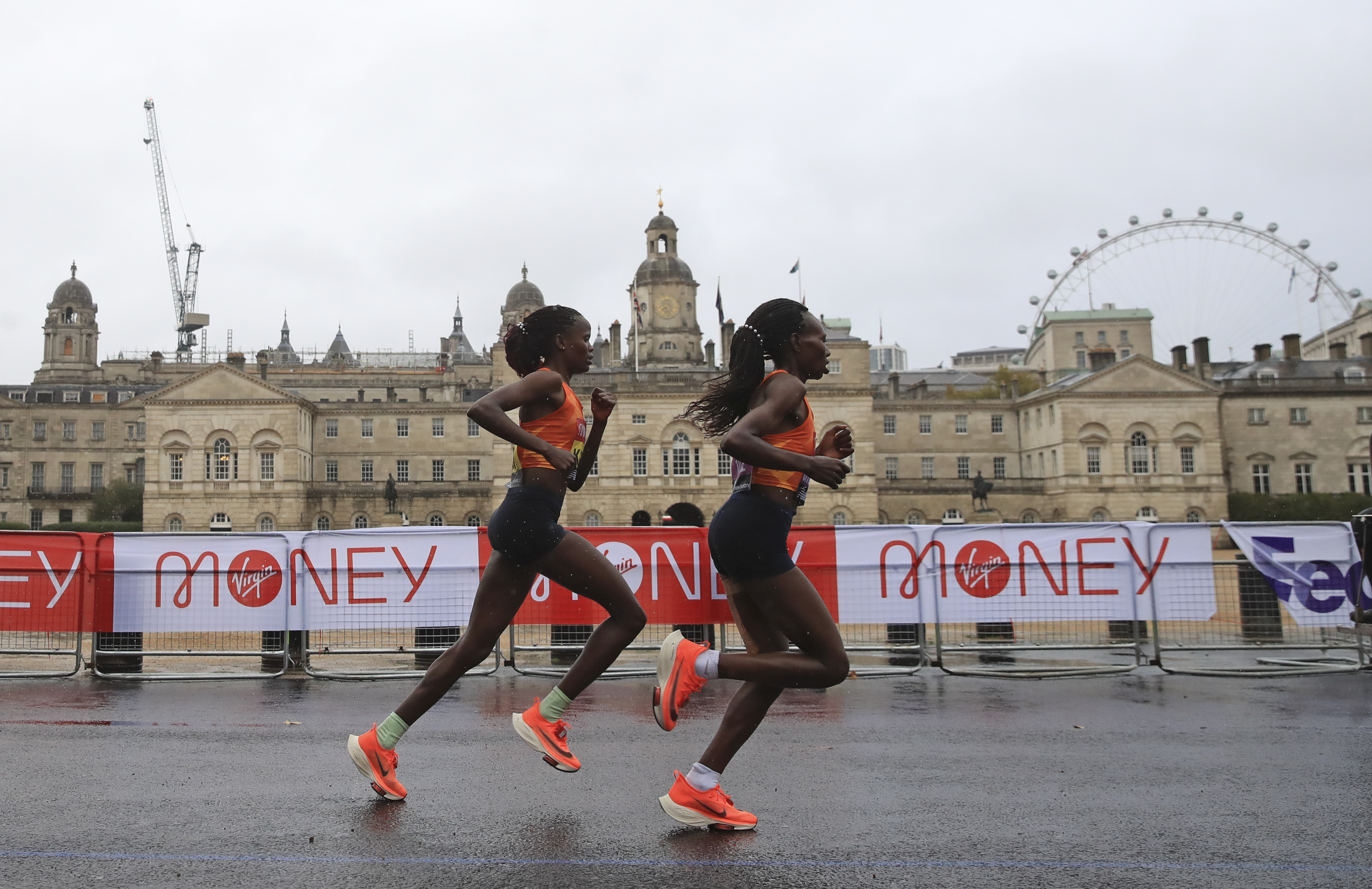 Kenya's Brigid Kosgei, left, and Kenya's Ruth Chepngetich race along Horseguards Parade during the London Marathon on Sunday.