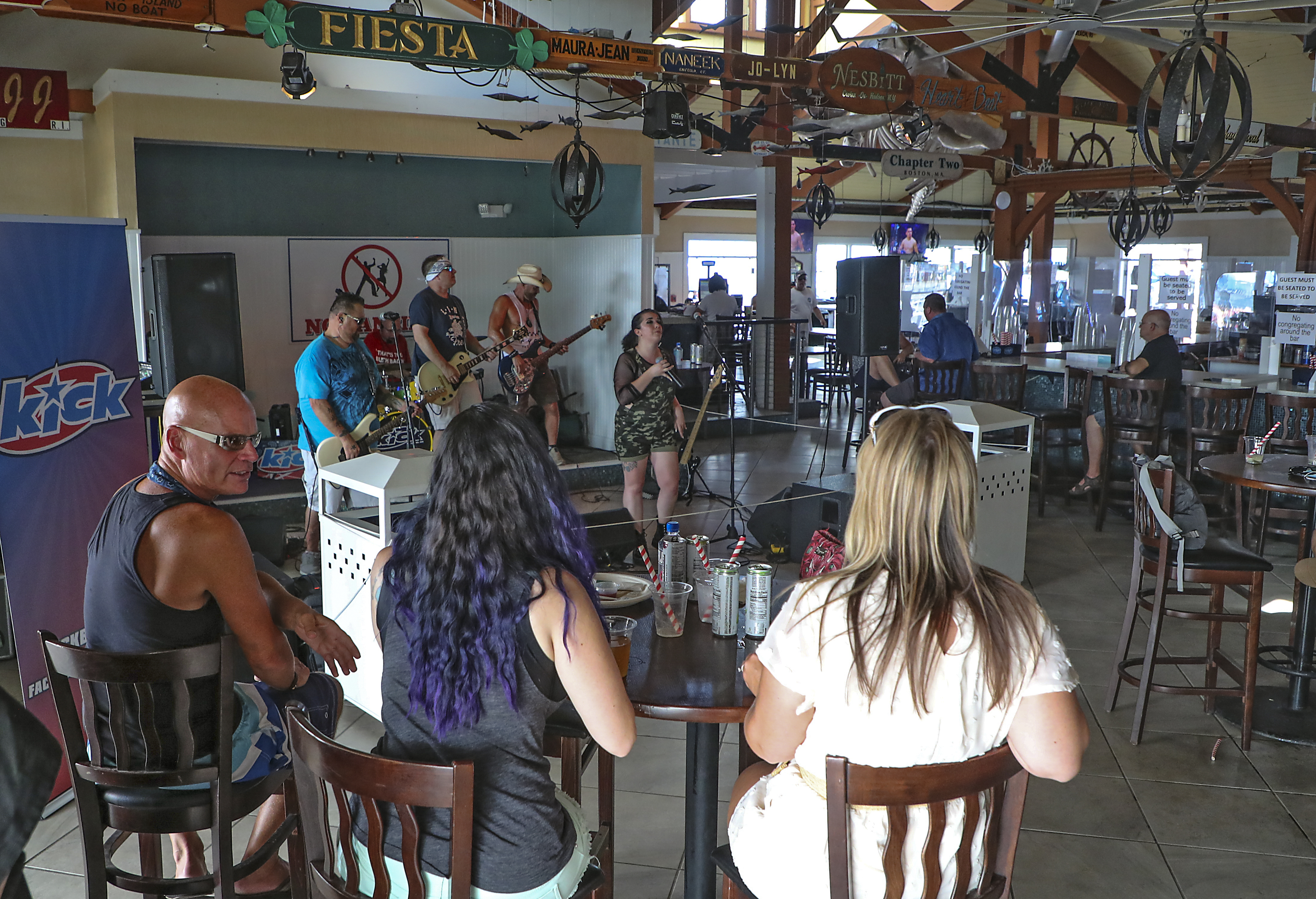 The band Kick performs indoors at Ballard's Restaurant on Block Island. A sign behind them instructs patrons "No dancing."