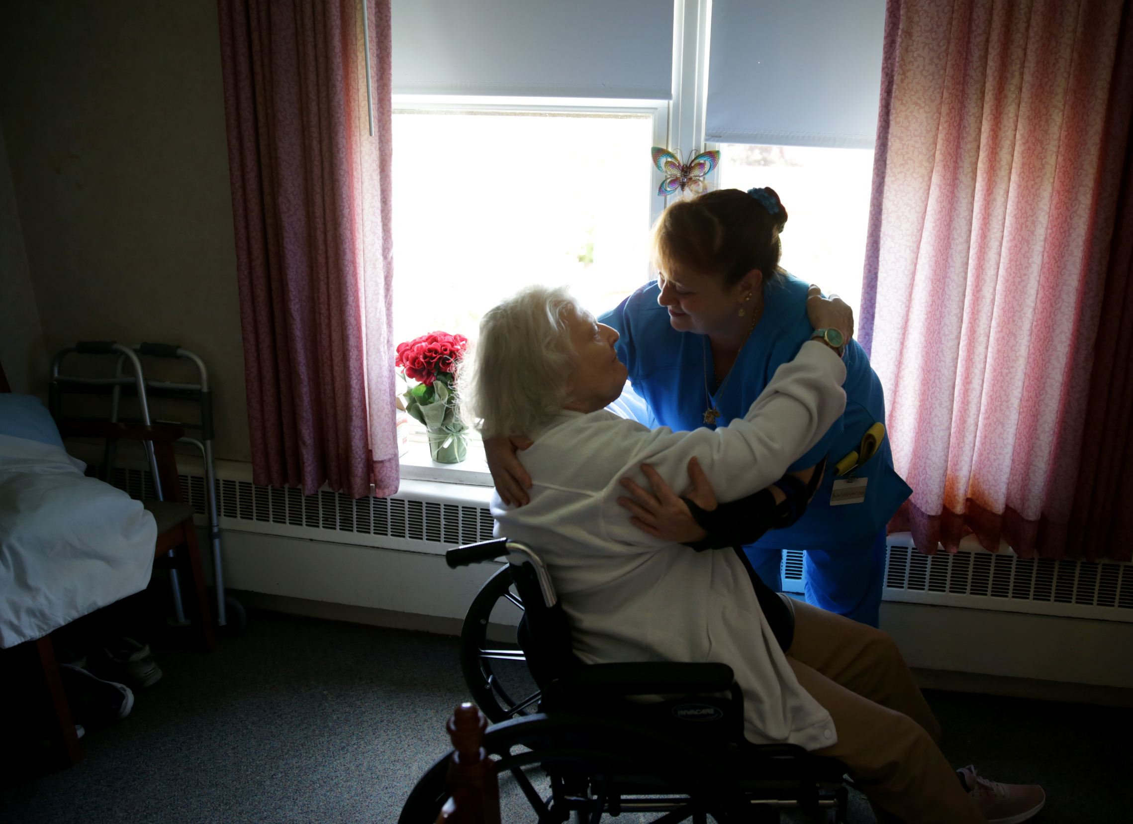 Katherine Lapre (left) with Certified Nursing Assistant Rachel Moreau at Brandon Woods nursing home in South Dartmouth on June 14.