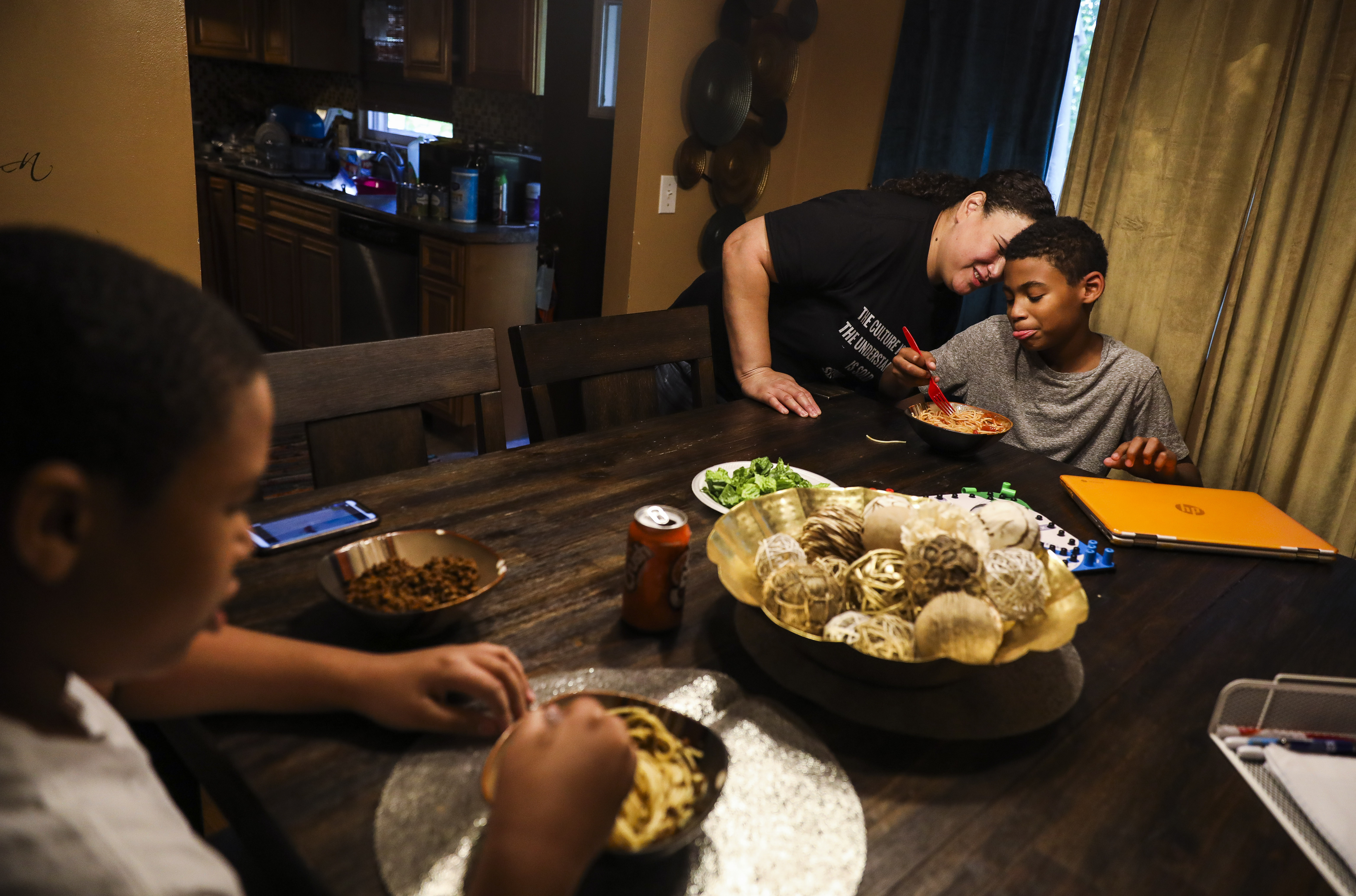 Yahaira Lopez served lunch to her twin boys, Yassiah and Yamir (left) while they took a break from remote learning in their Randolph home.