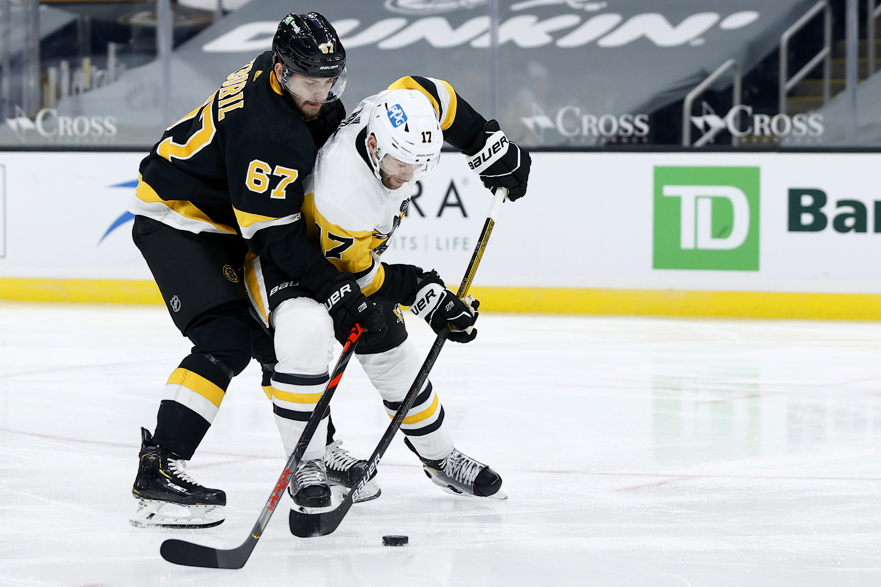Boston Bruins' Charlie Coyle (13) grabs the jersey of Pittsburgh Penguins'  Brian Dumoulin (8) during the second period of an NHL hockey game in  Pittsburgh, Sunday, April 25, 2021. The Penguins won